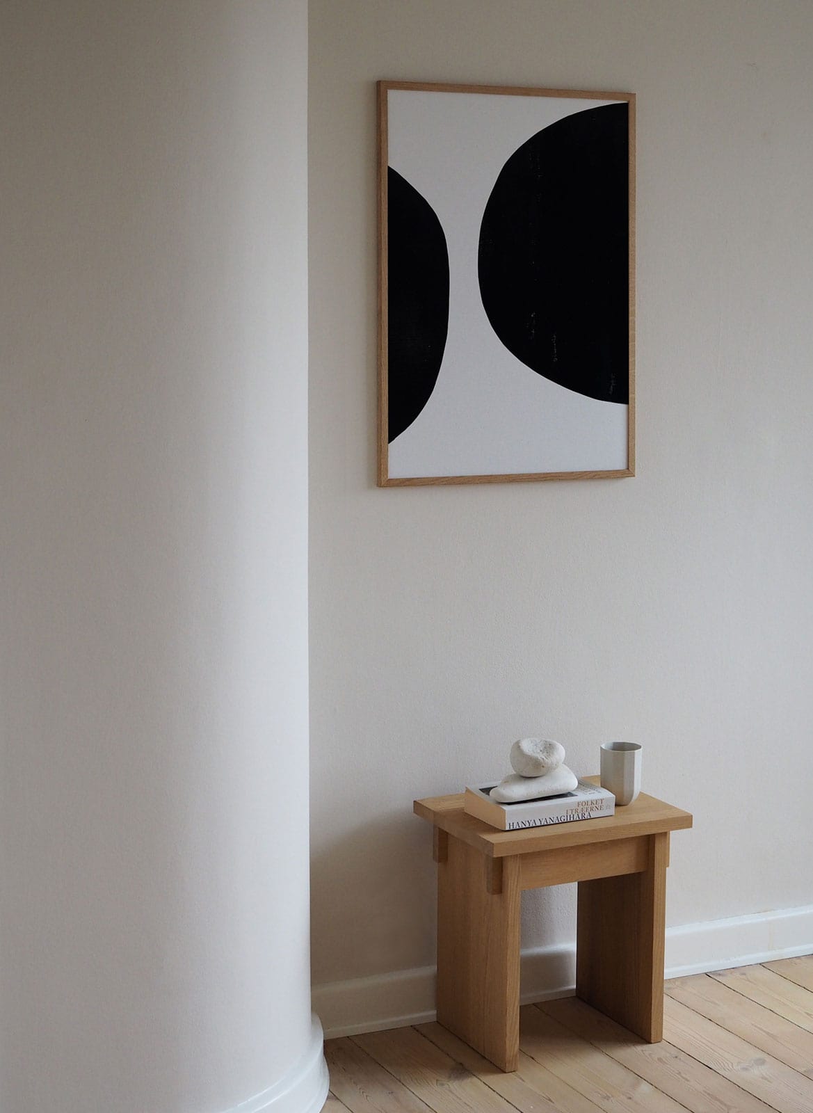 Framed black and white poster hanging in a living room by Atelier Cph