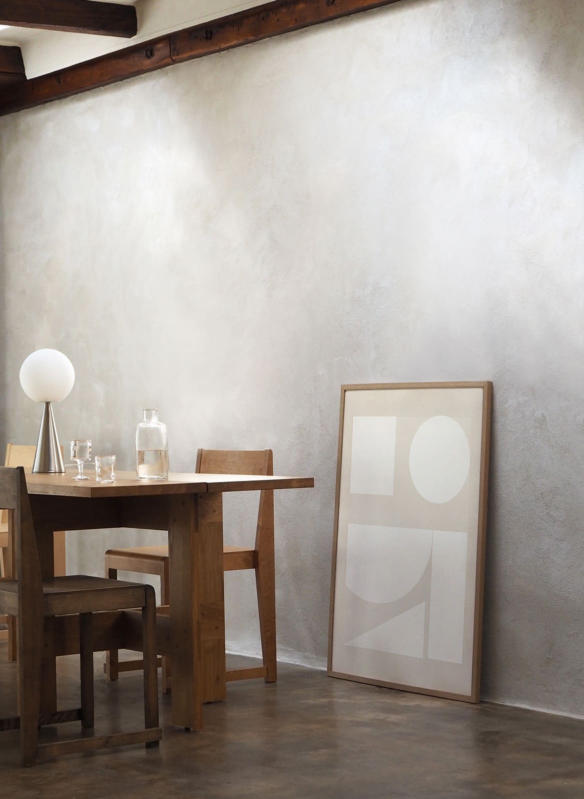Framed minimalistic poster standing in a living room by Atelier Cph