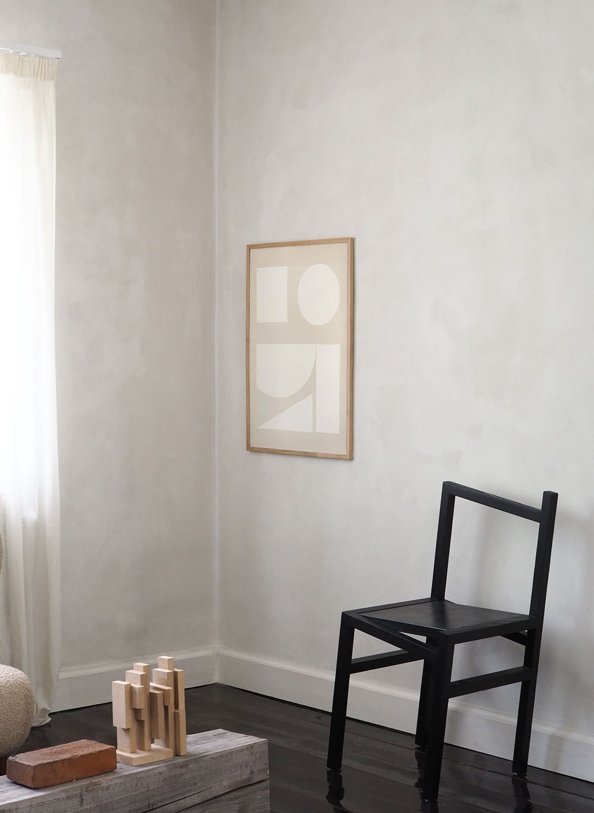 Framed minimalistic poster hanging in a living room by Atelier Cph