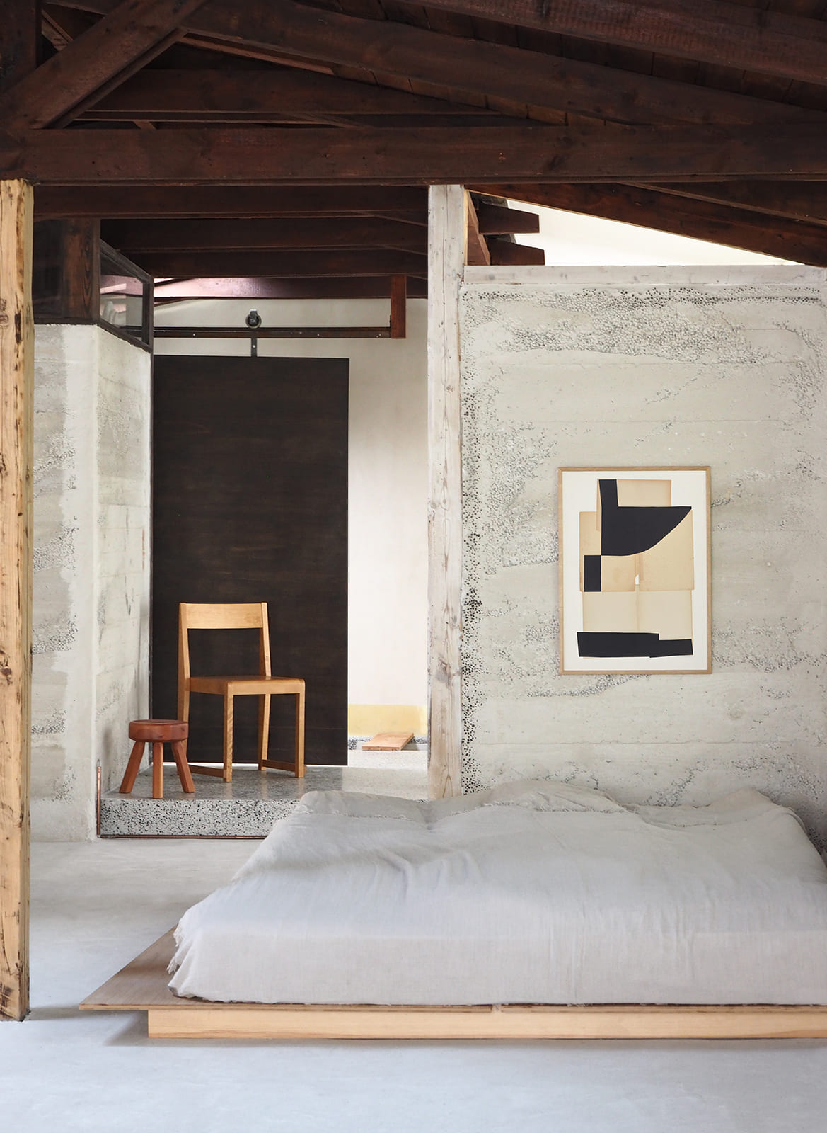 Framed minimalistic poster hanging in a bedroom by Atelier Cph