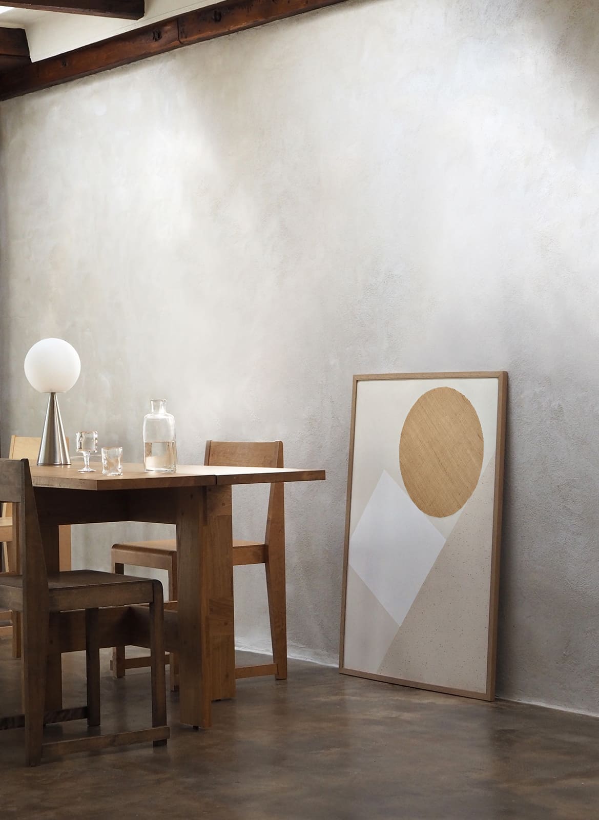 Framed minimalistic poster standing in a living room by Atelier Cph