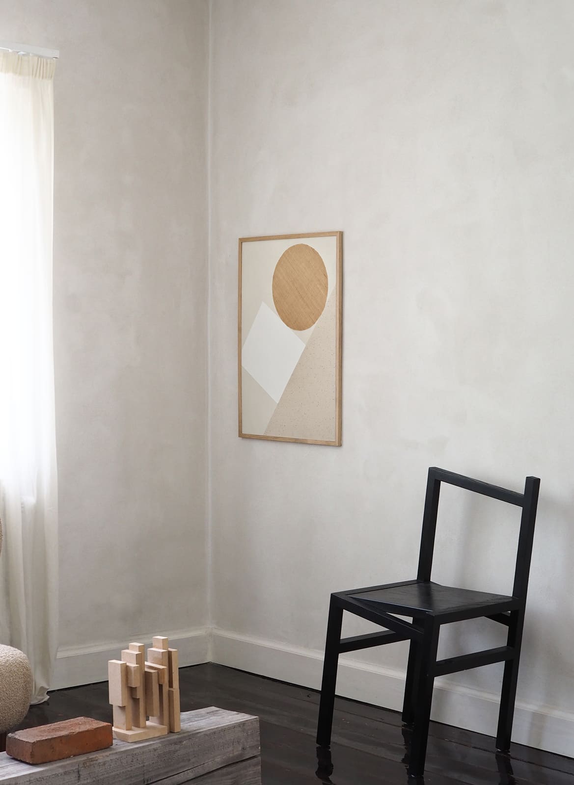 Framed minimalist poster hanging in a living room by Atelier Cph