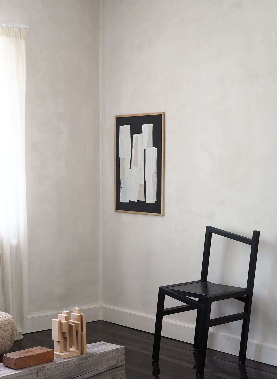 Framed minimalistic poster hanging in a living room by Atelier Cph