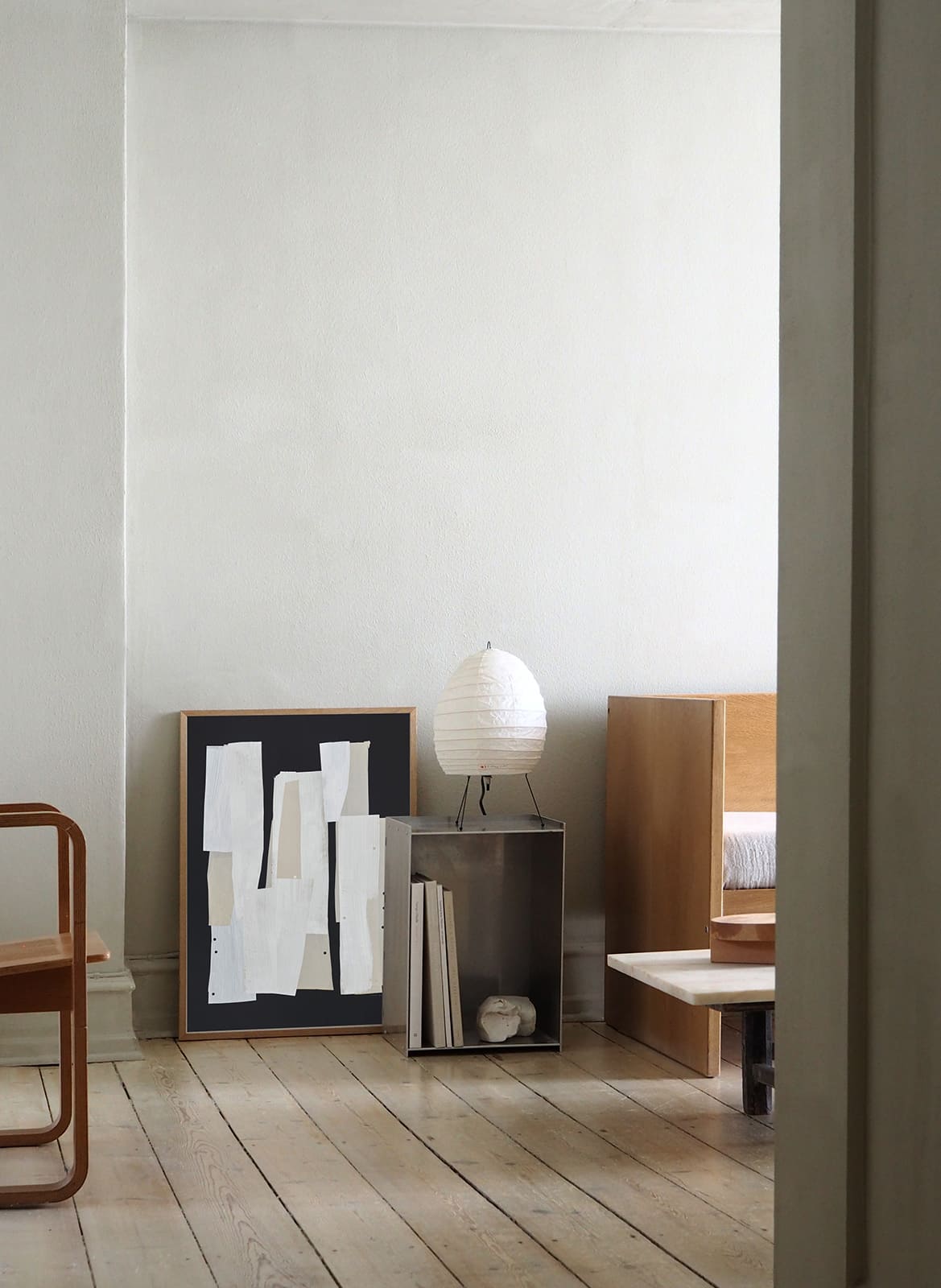 Framed minimalistic poster standing in a living room by Atelier Cph