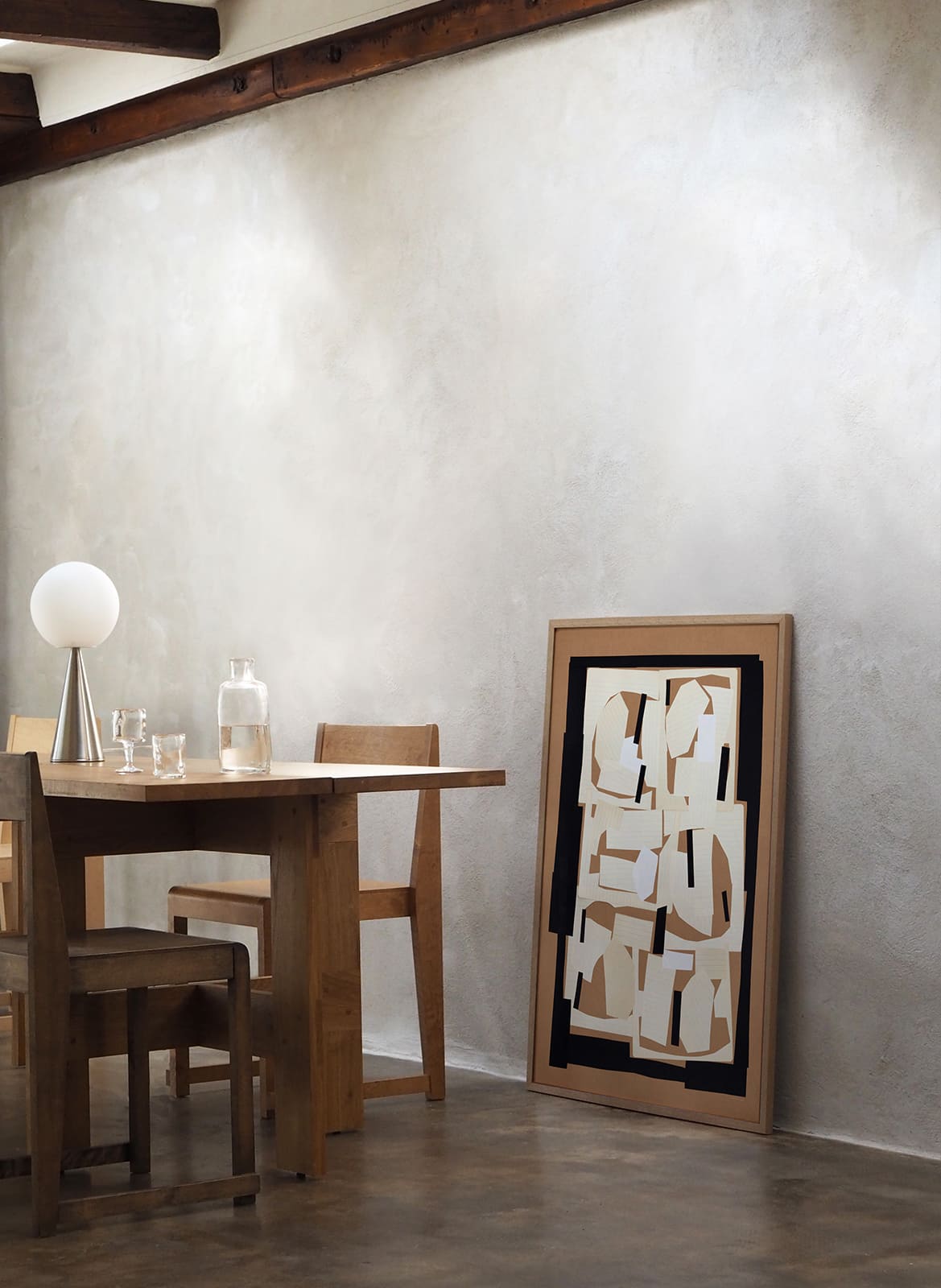 Framed minimalistic poster standing in a living room by Atelier Cph