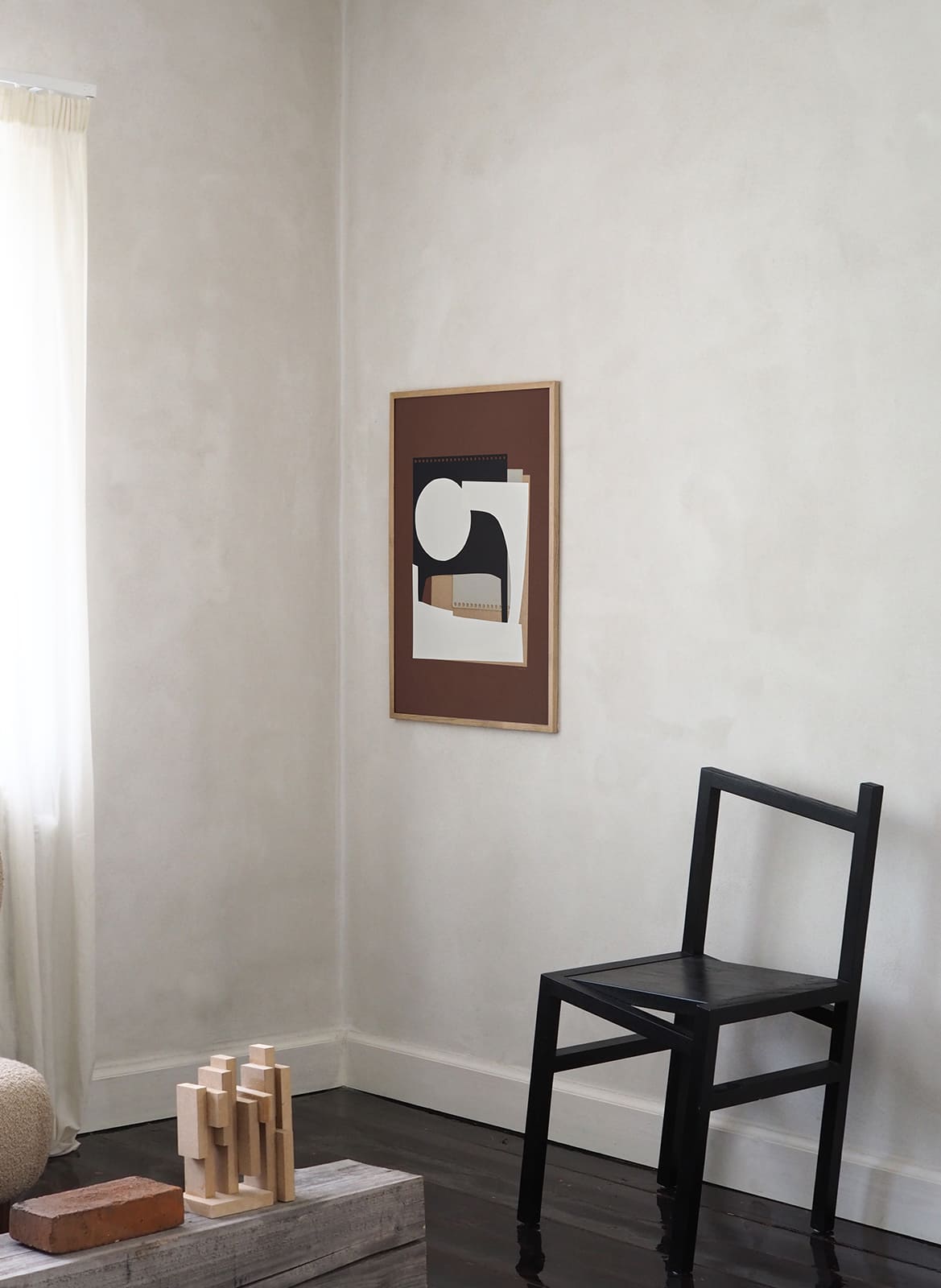 Framed minimalistic poster hanging in a living room by Atelier Cph
