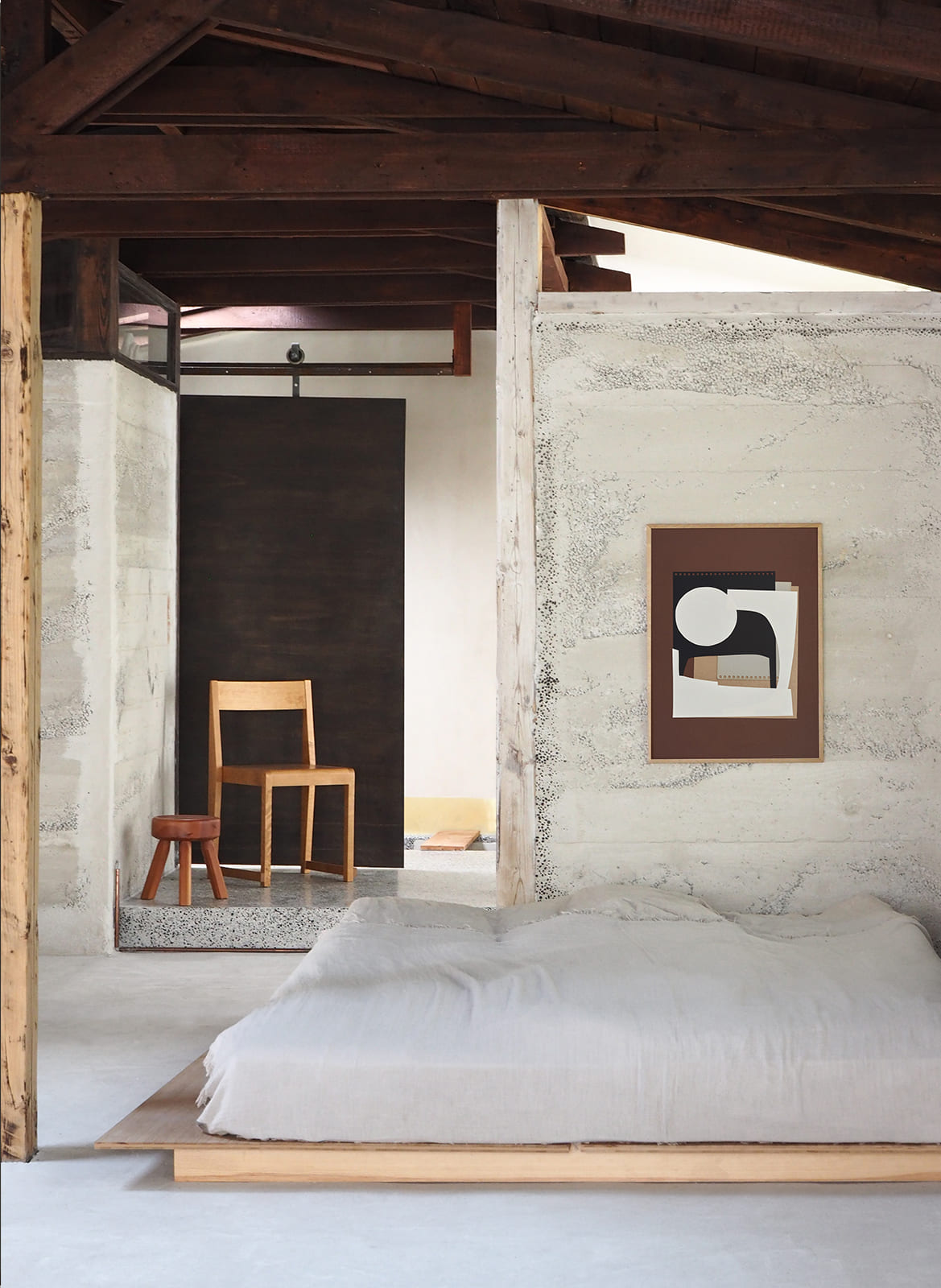 Framed minimalistic poster hanging in a bedroom by Atelier Cph