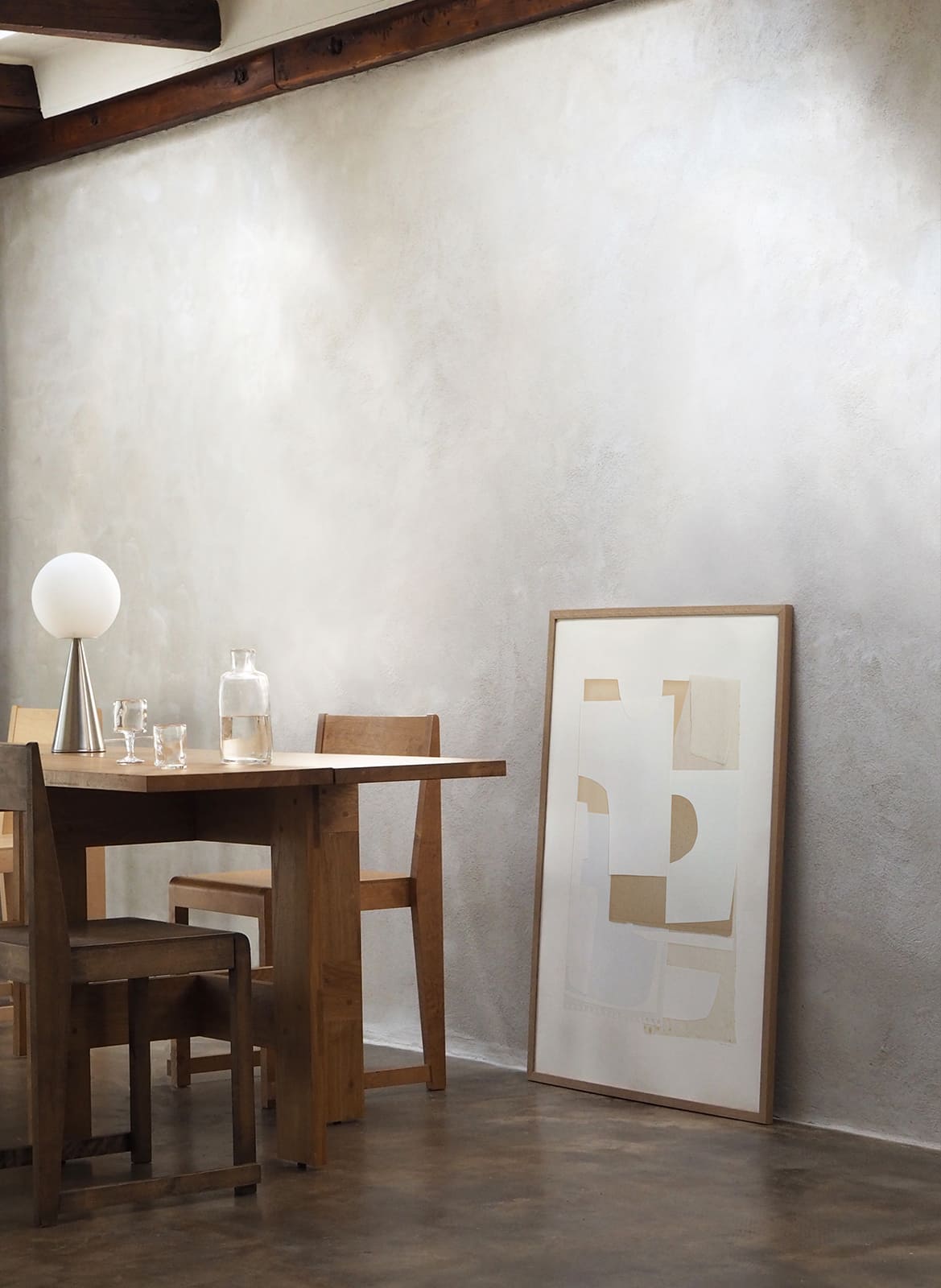 Framed minimalistic poster standing in a living room by Atelier Cph