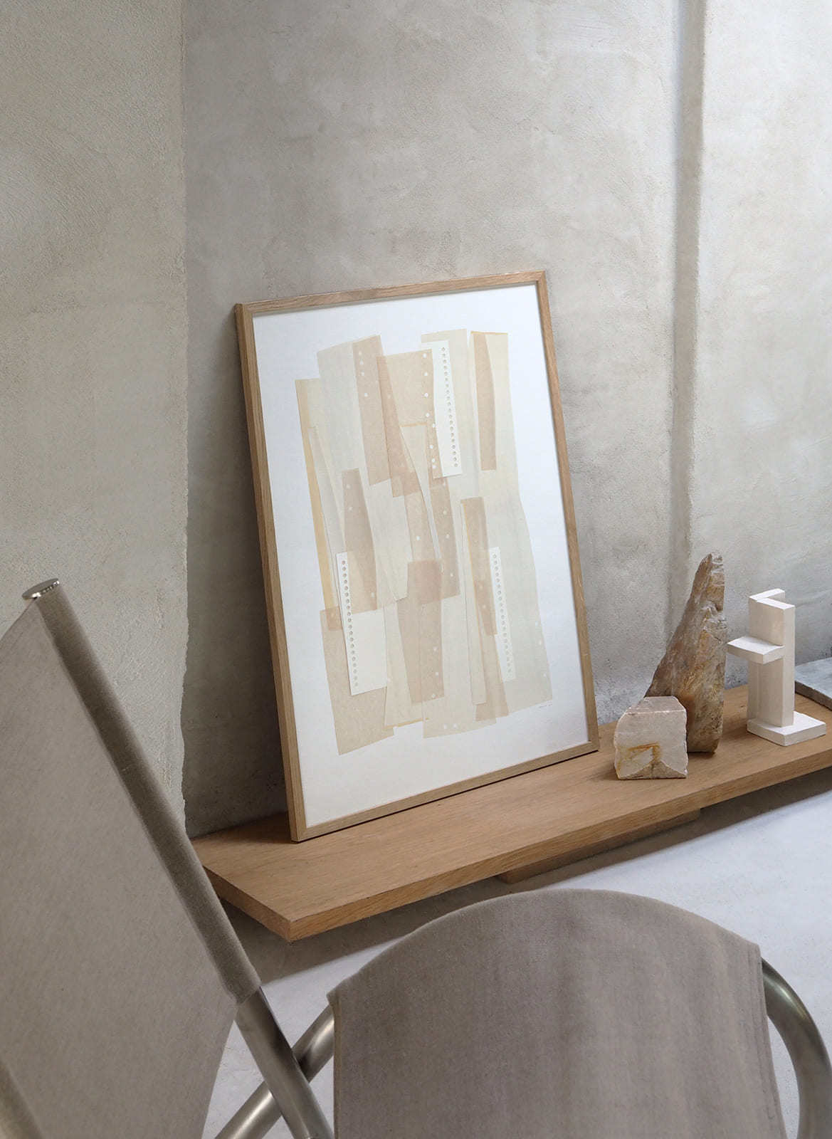 Framed minimalistic poster standing in a living room by Atelier Cph