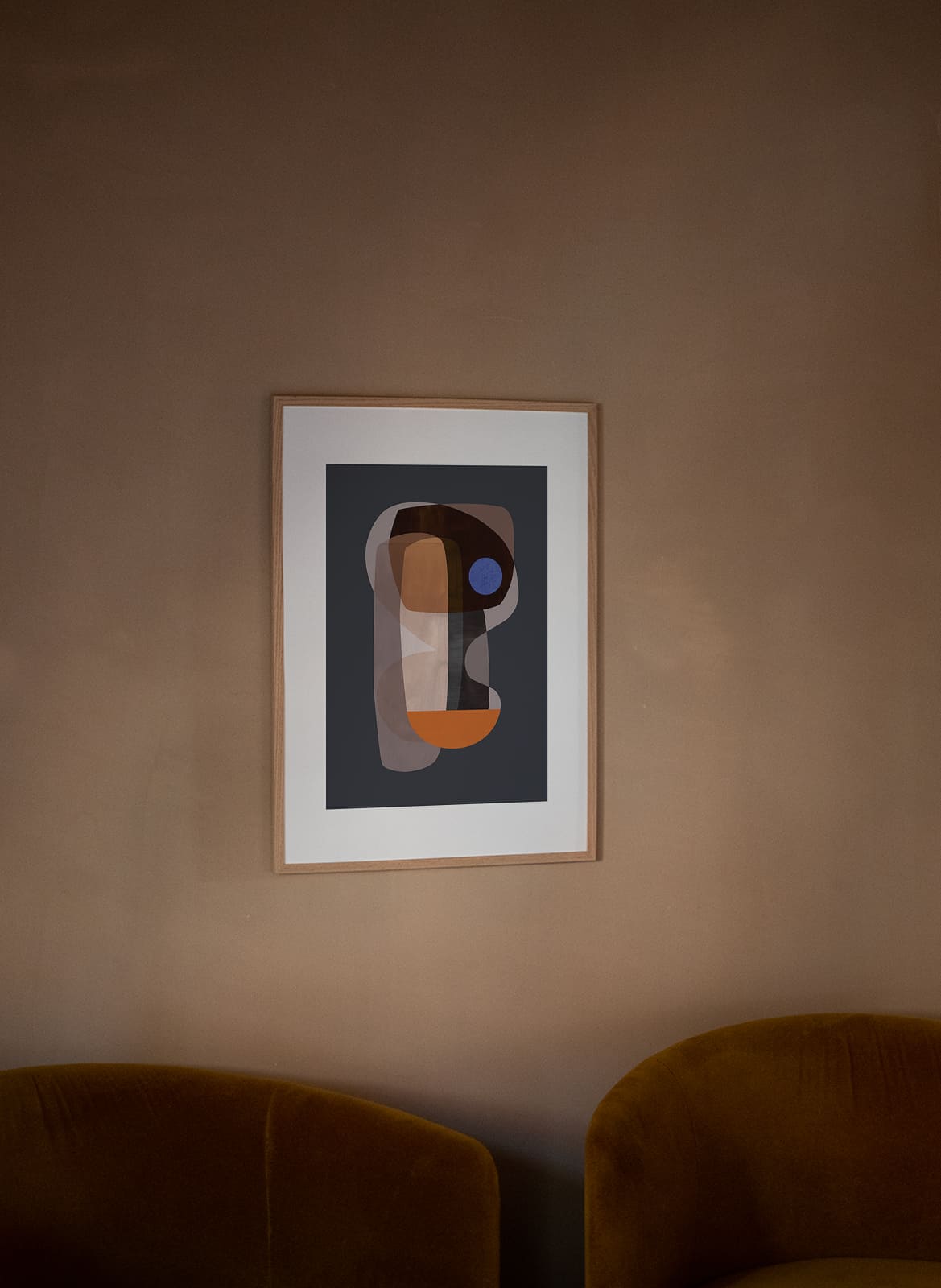 Colourful abstract poster hanging above a couch by atelier cph
