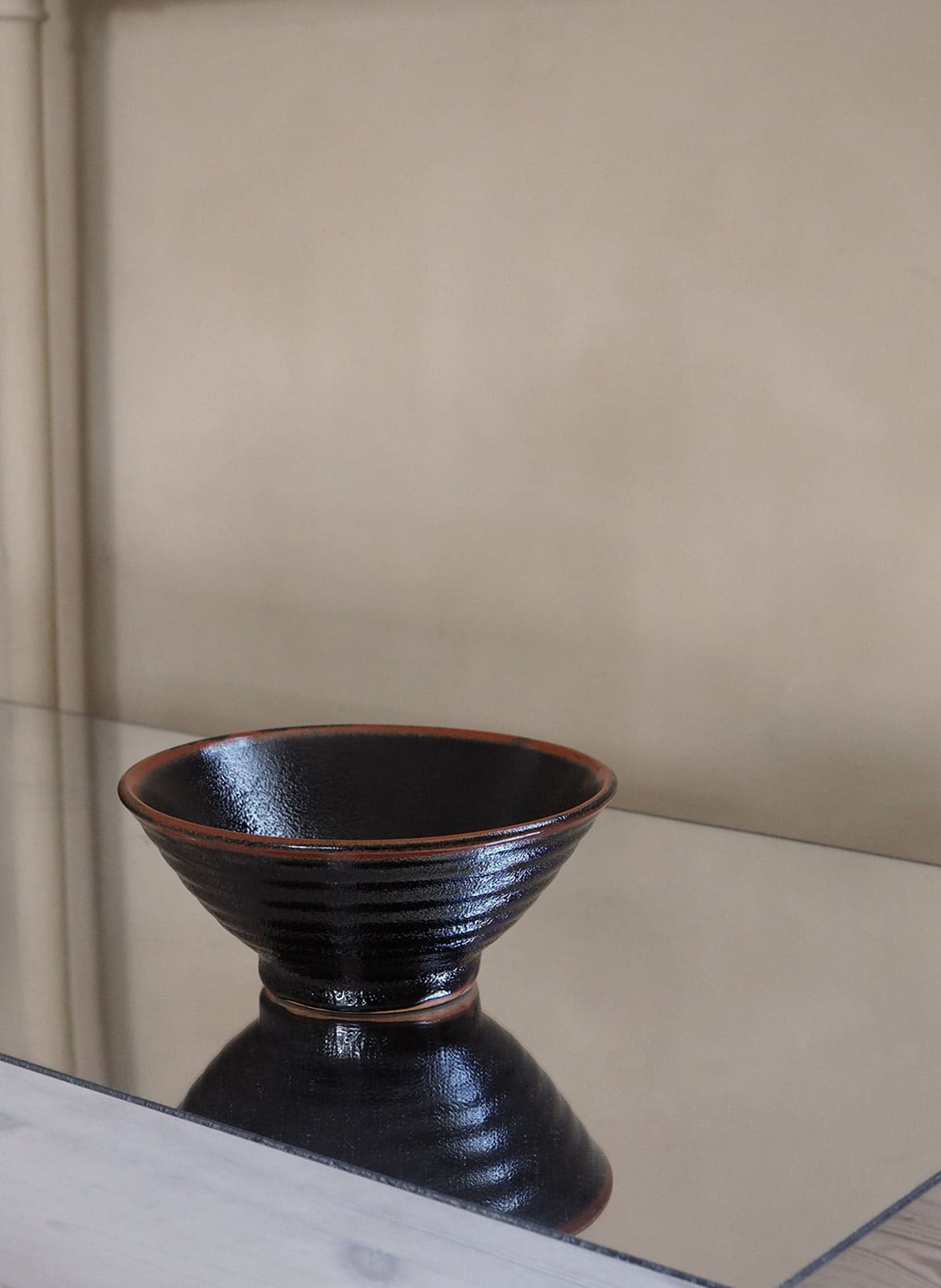 vintage black Japanese ceramic bowl with a brown edge