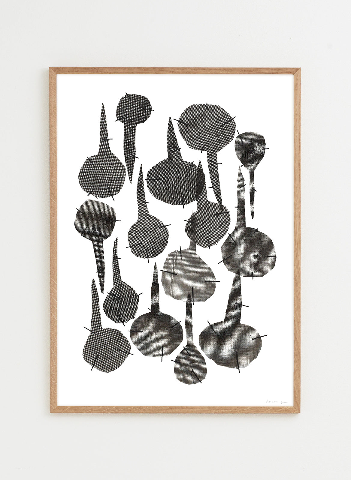 Framed artwork with black abstract shapes on a white background