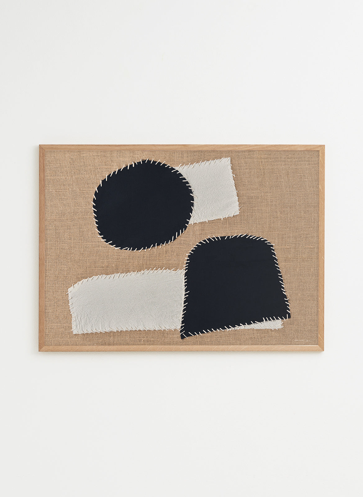 Abstract art piece with black and white shapes on a beige background