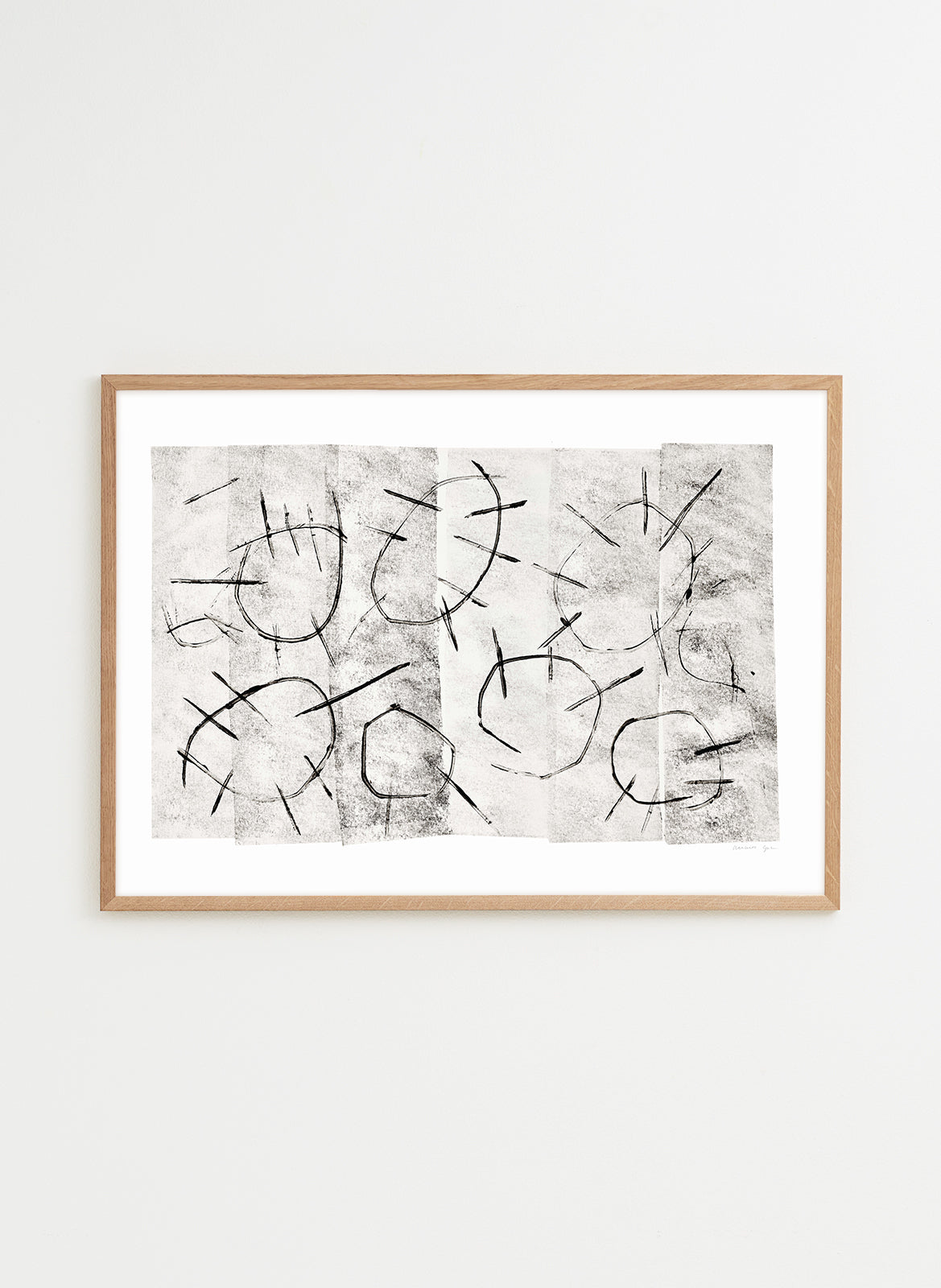 Abstract art print with black lines on a textured white background, framed in wood.