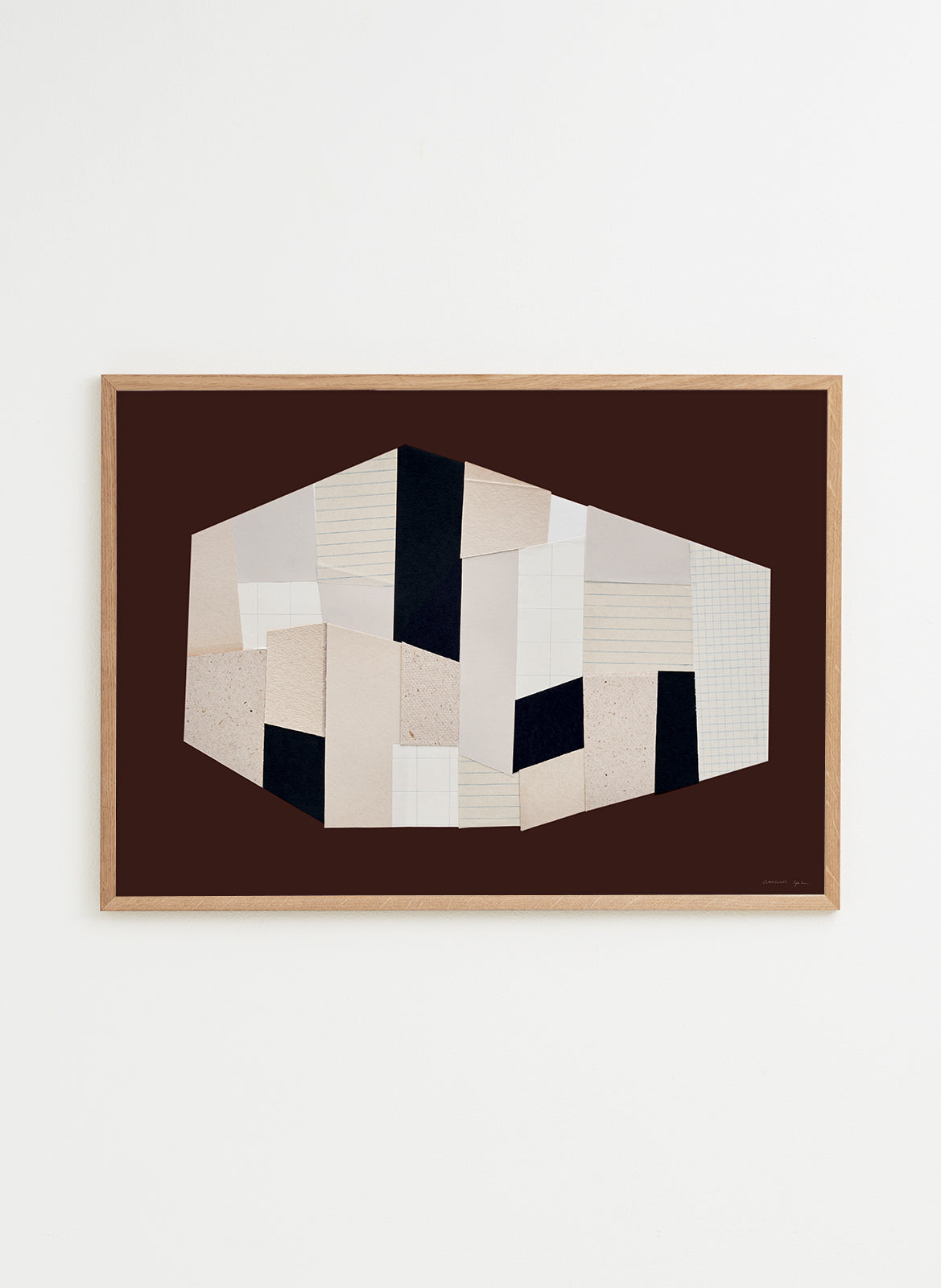 Framed abstract art piece with geometric shapes on a white wall