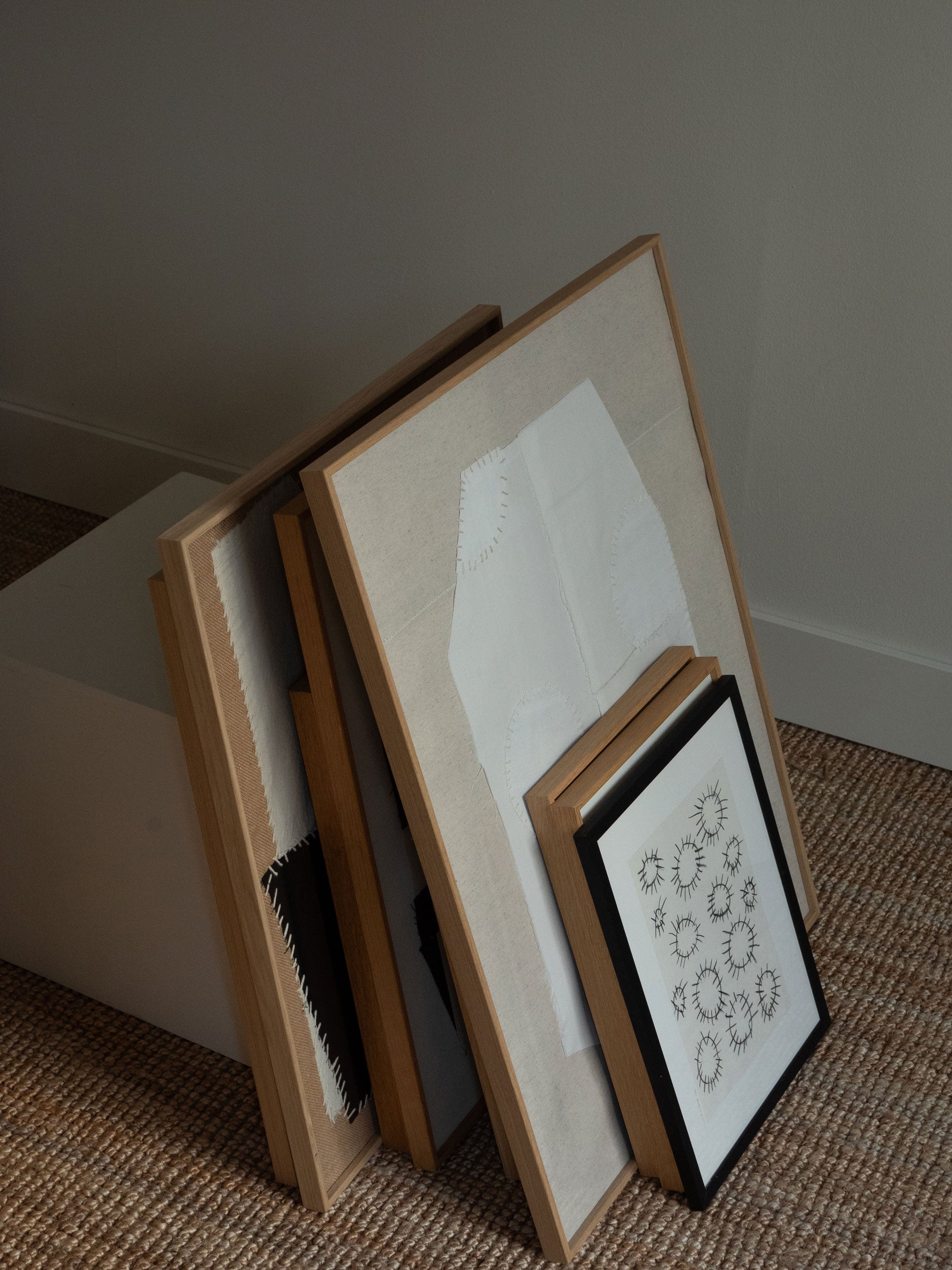 Framed artwork by atelier cph leaning against a box in the atelier cph studio in copenhagen.
