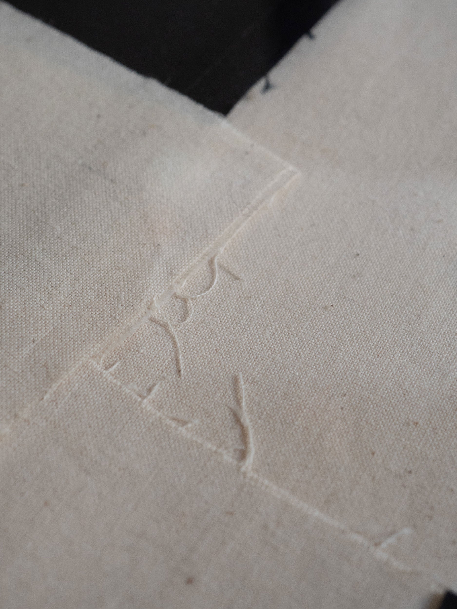 Close-up of textured beige fabric with a subtle pattern