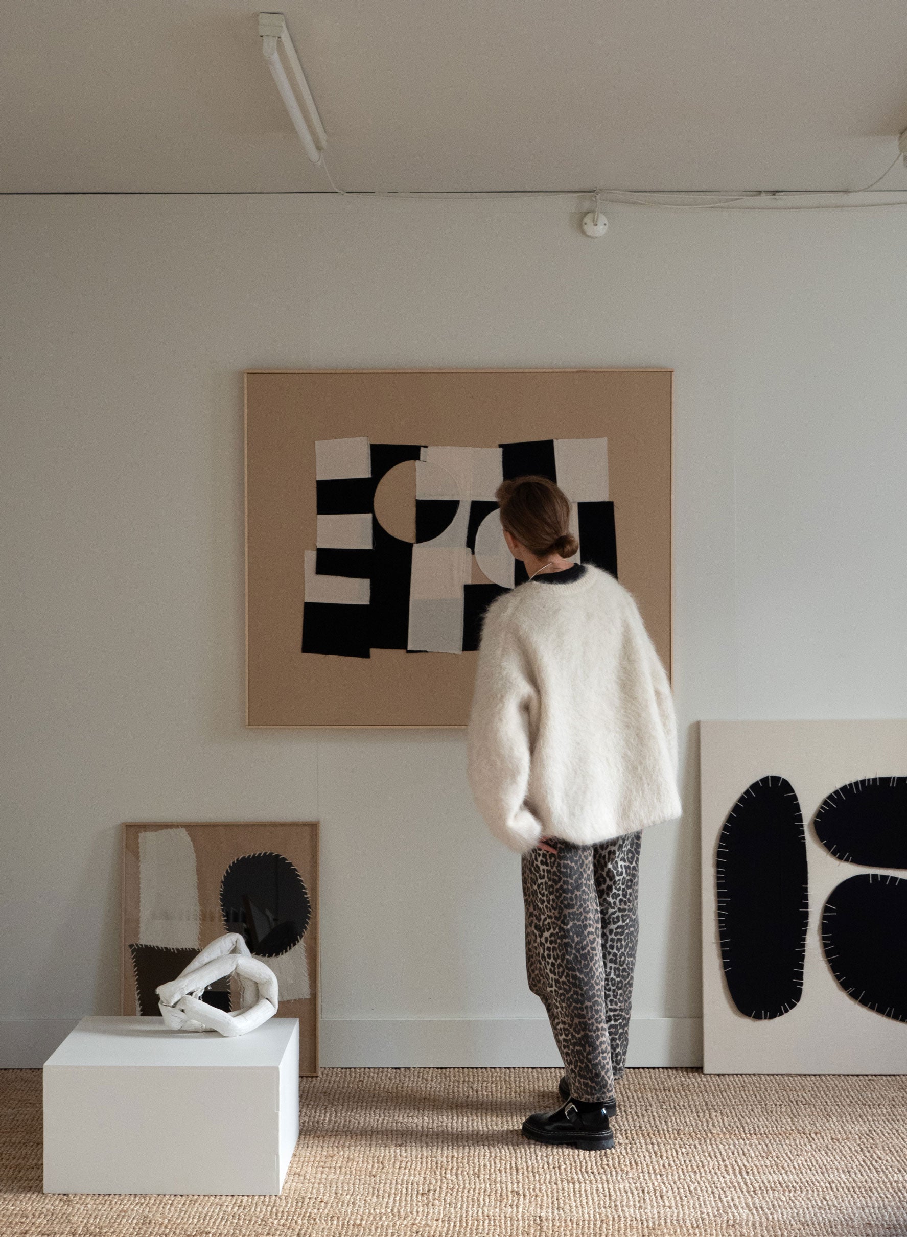 Person standing in a room with abstract art on the wall created by Atelier Cph
