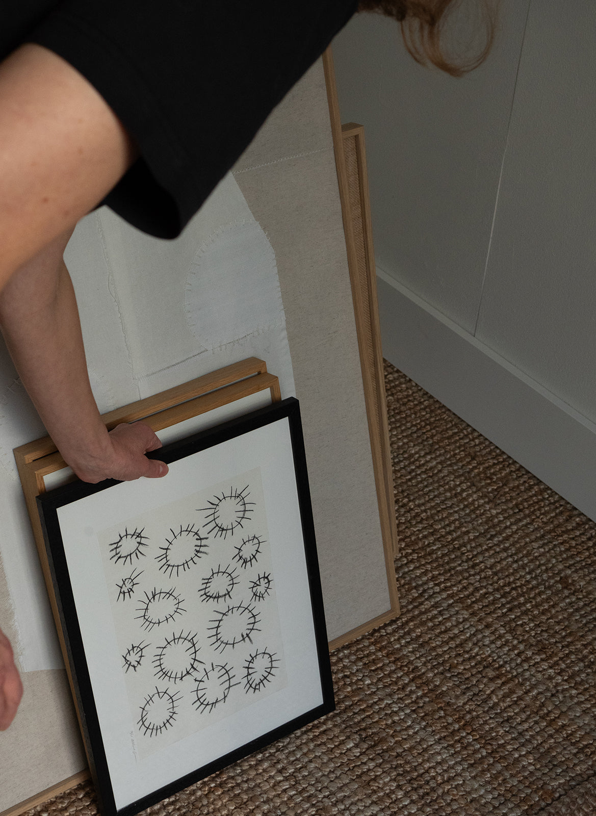 Person holding a limited edition piece of paper featuring black line art on a white background made by atelier cph