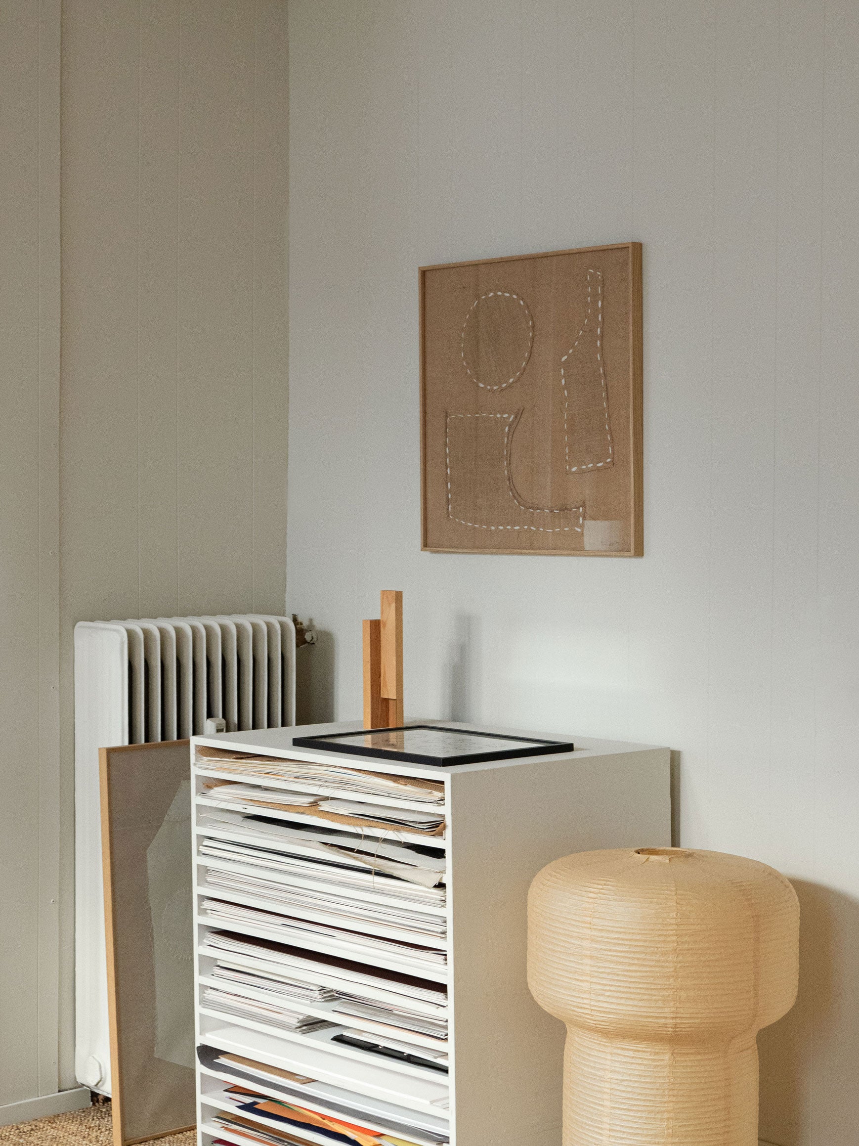 Minimalist textile artwork with stitched curved shapes and white lines on hessian fabric, framed in light oak, created as a limited edition by Atelier Cph