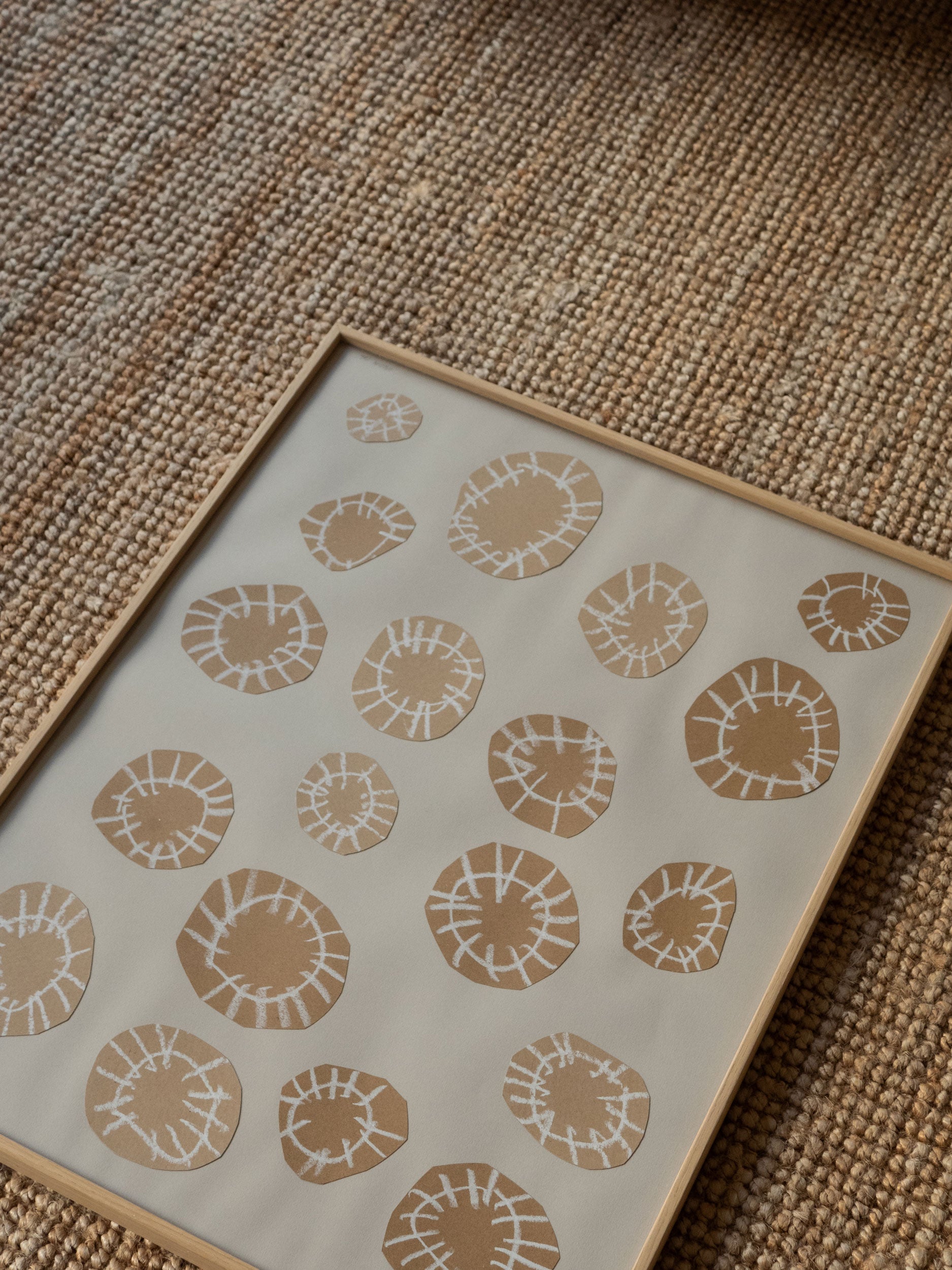 Minimalist artwork with sand-coloured circular shapes and white linear details on a grey background, framed in light oak, created as a limited edition by Atelier Cph