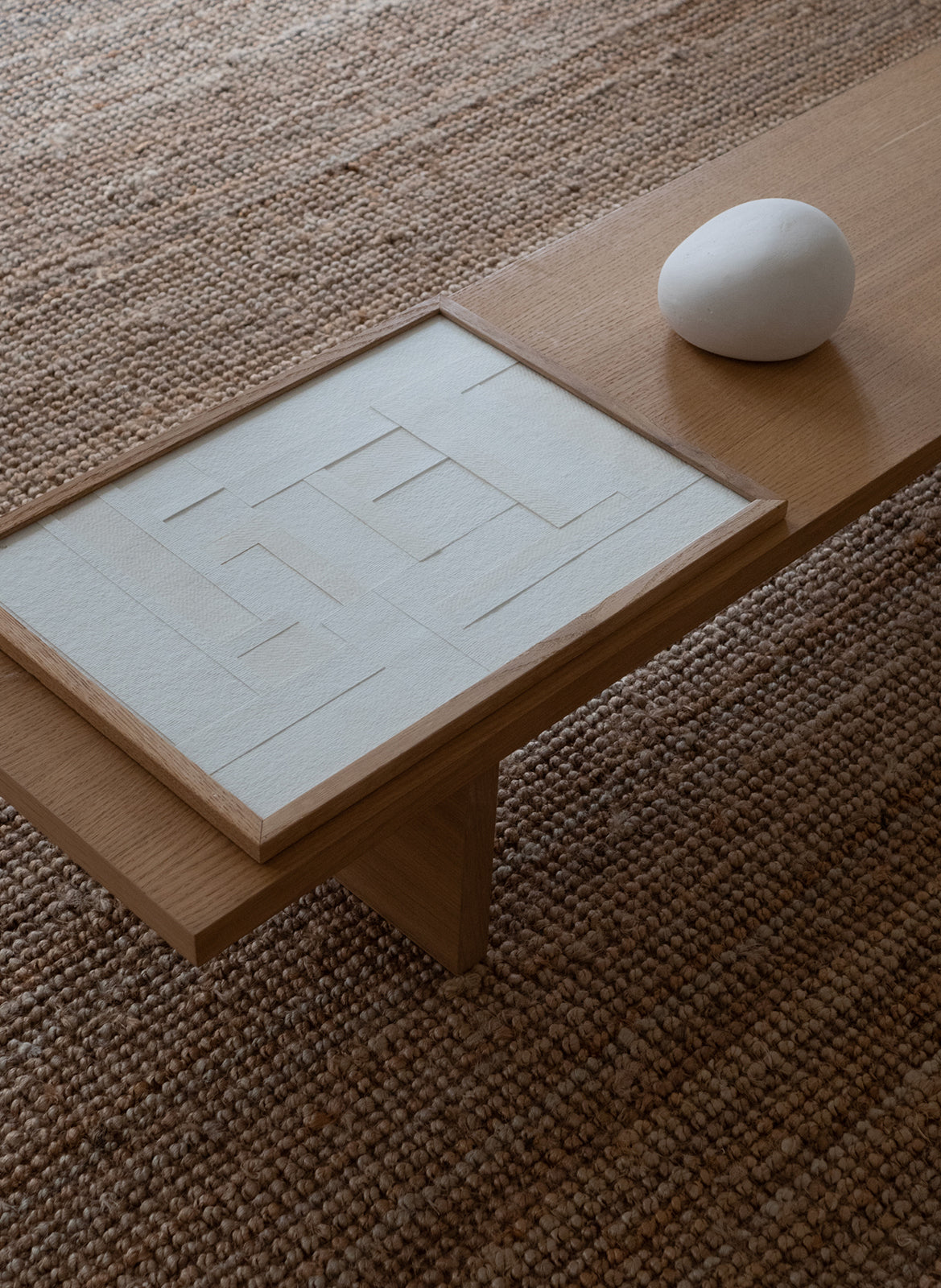 Minimalist white paper collage with layered geometric shapes in a light oak frame, created as a limited edition by Atelier Cph.