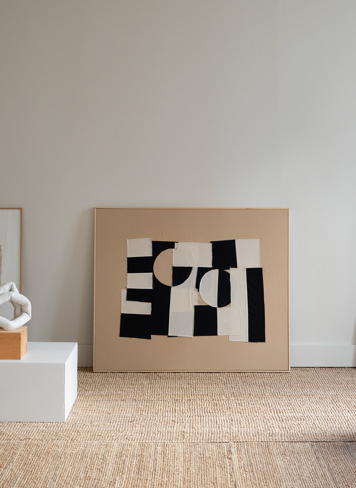 Abstract Atelier Cph art piece on a beige wall 