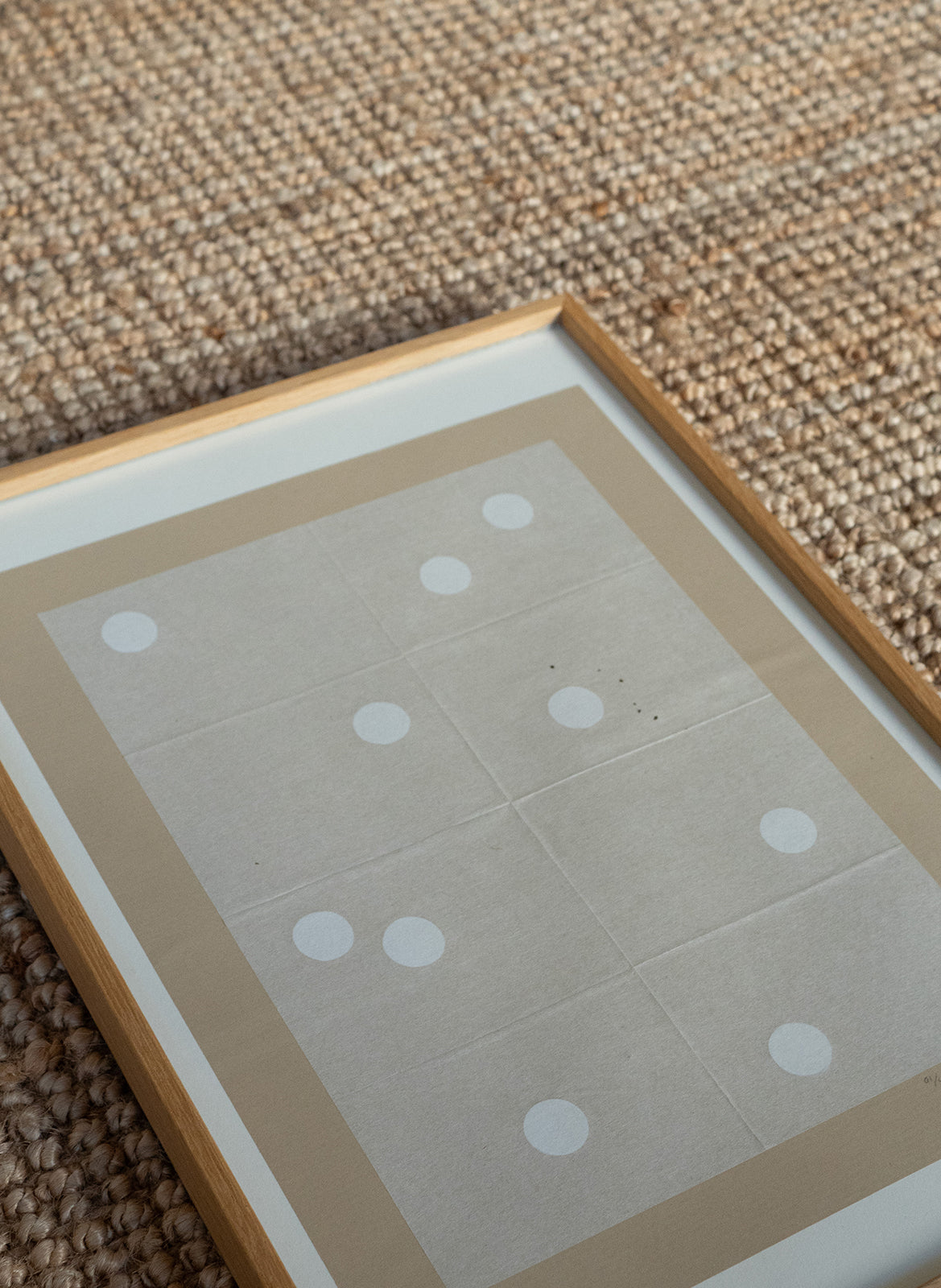 Framed paper with polka dots on a textured surface by atelier cph