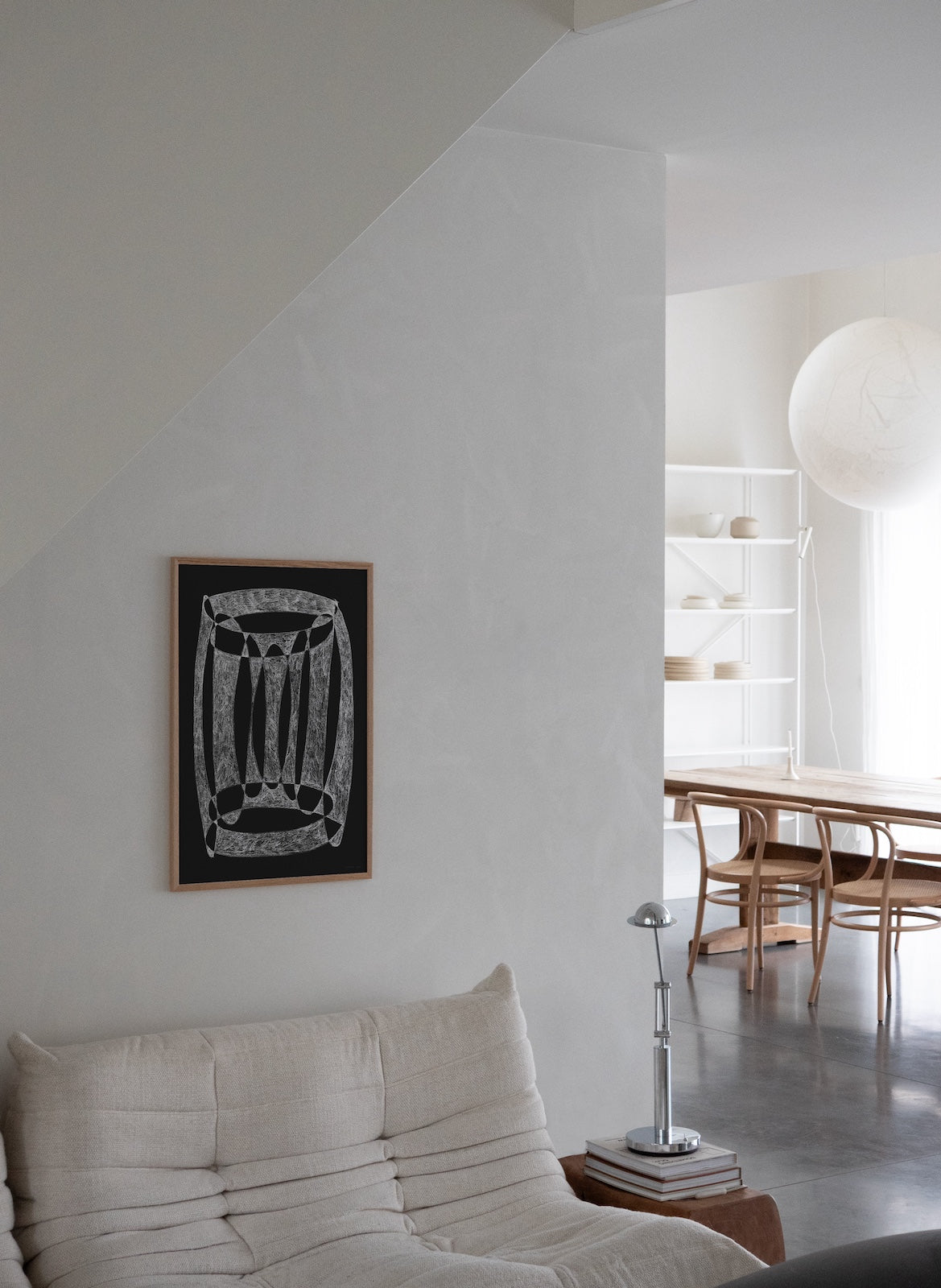 sofa i minimalistic home with art piece on the wall