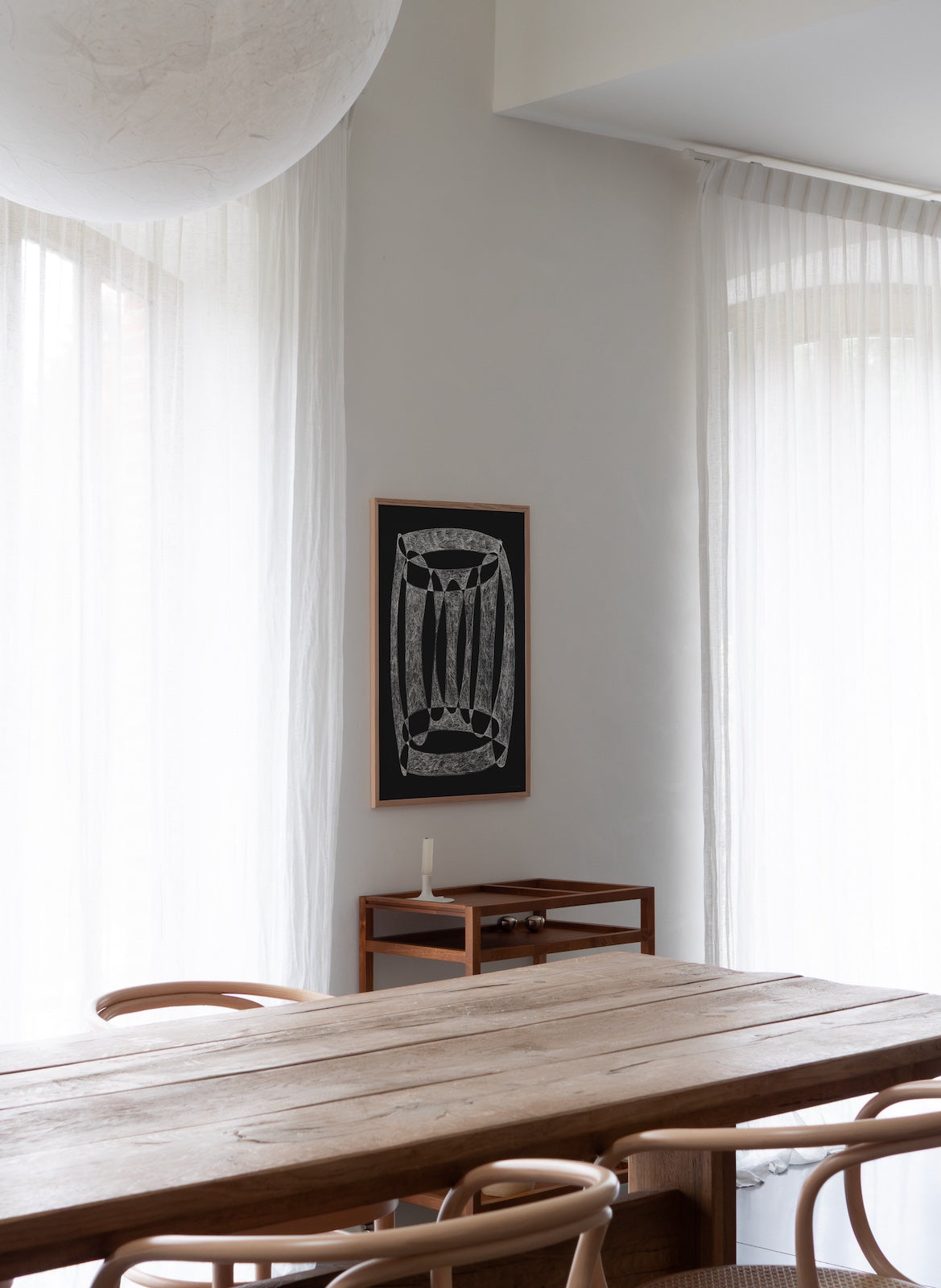 table setting with black art piece on the wall