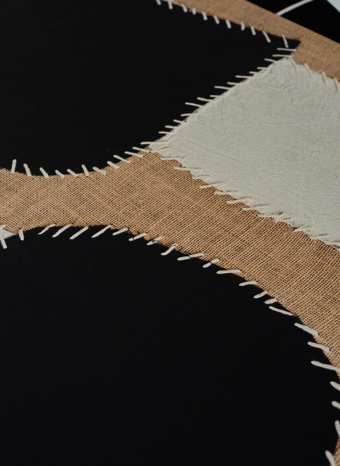 Close-up of fabric swatches in brown, beige, and black.