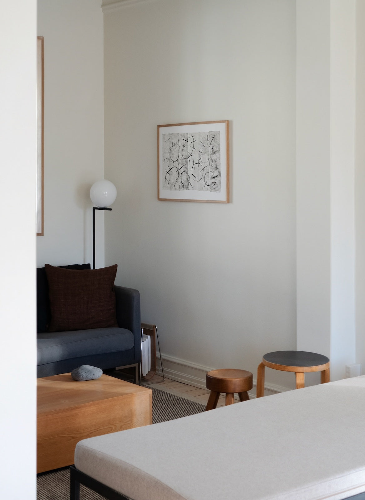 Modern living room with a sofa, coffee table, and wall art.