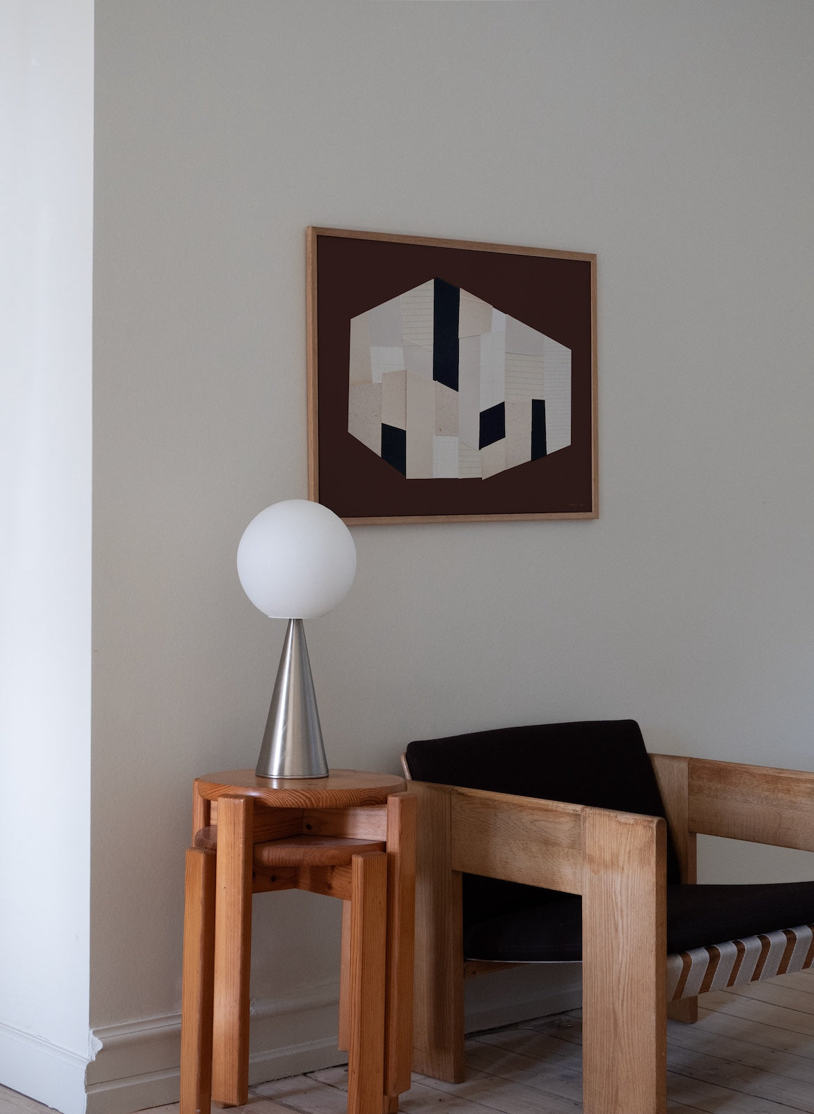 Modern interior with wooden chair, side table, and abstract art on the wall.