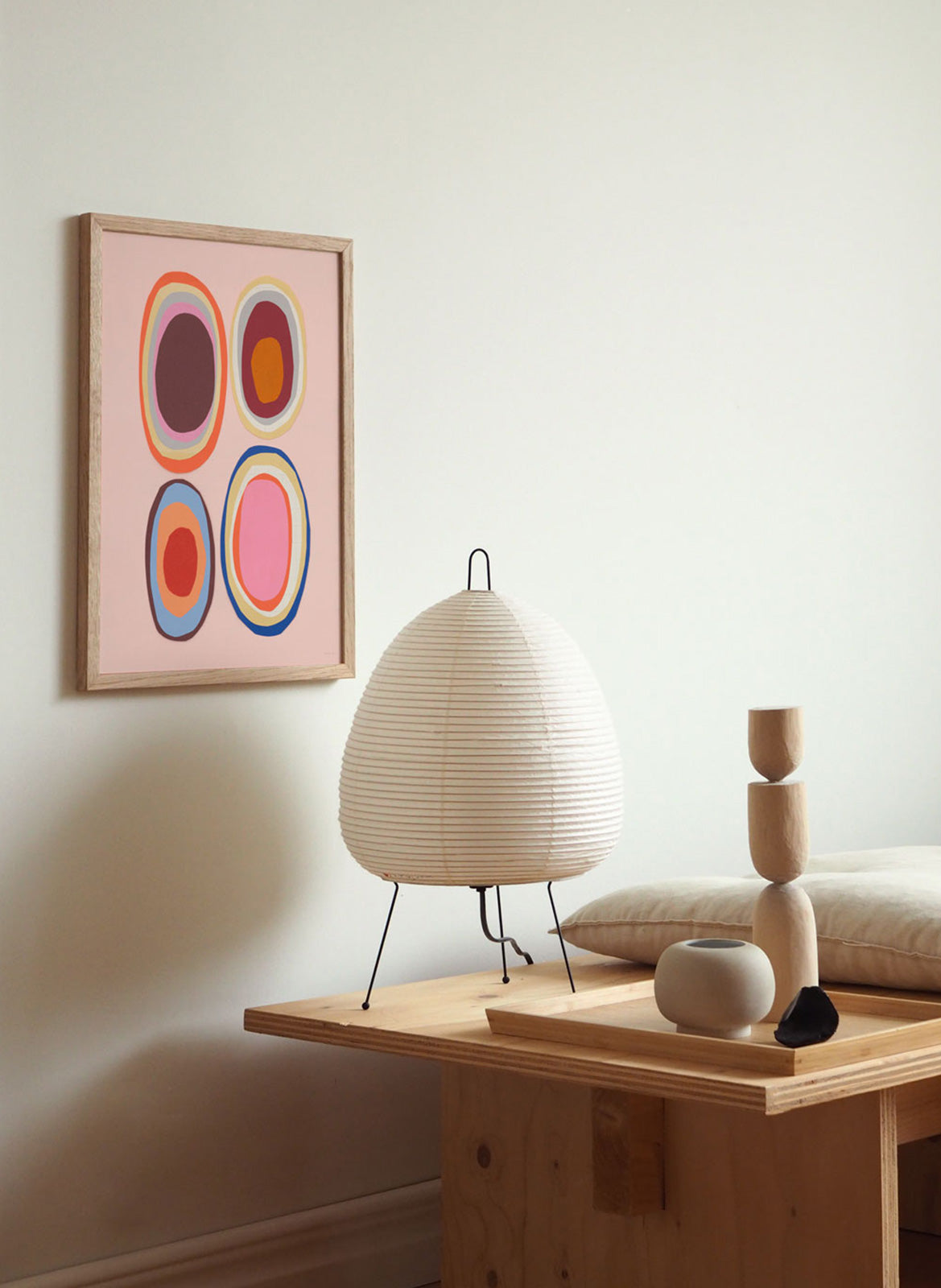 Framed colorful pink poster hanging in a living room by Atelier Cph