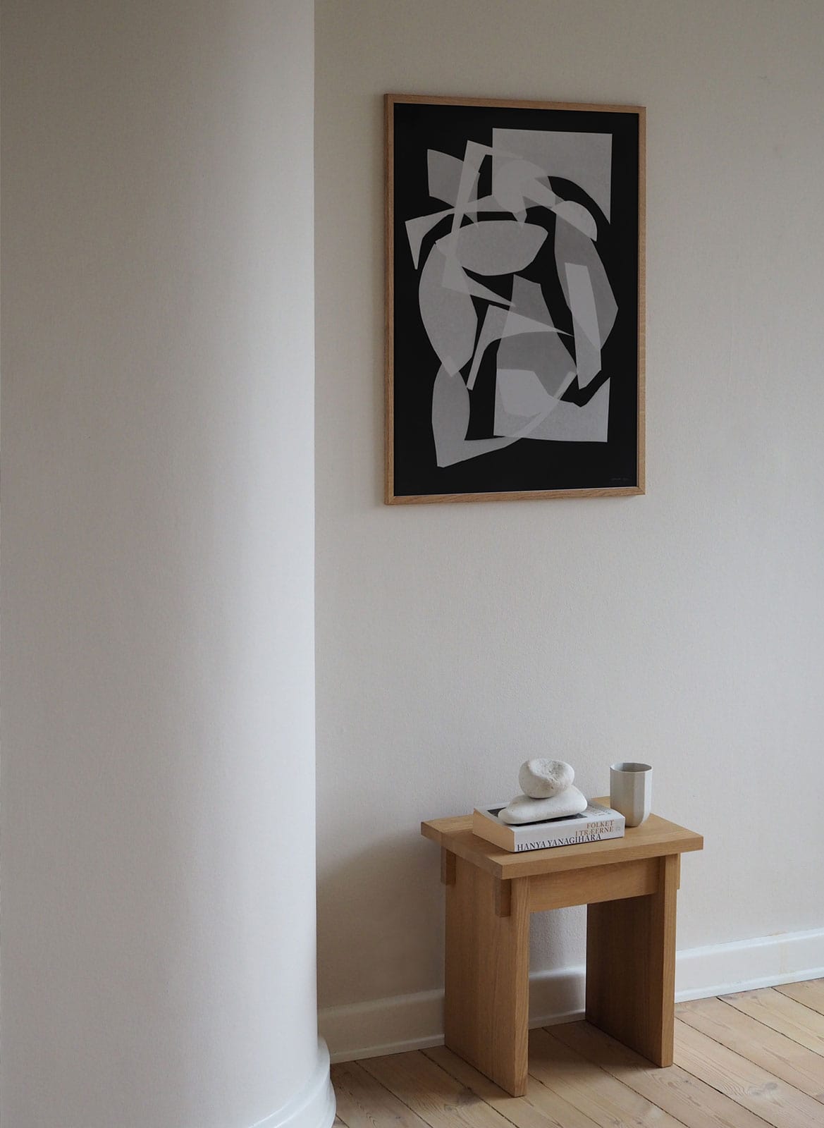 Framed minimalistic poster hanging above a table by Atelier Cph
