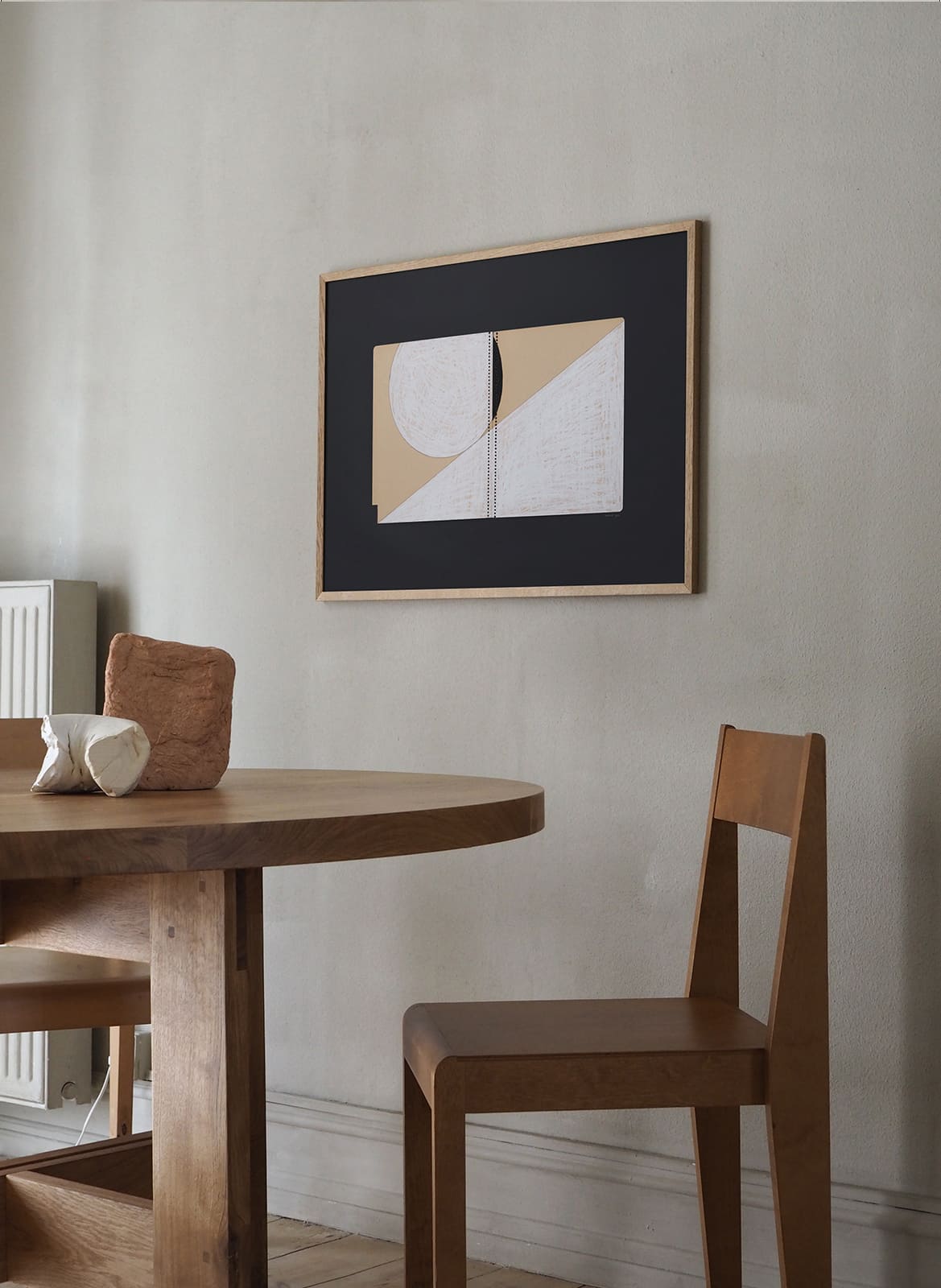   Framed minimalistic posters hanging above a table by Atelier Cph