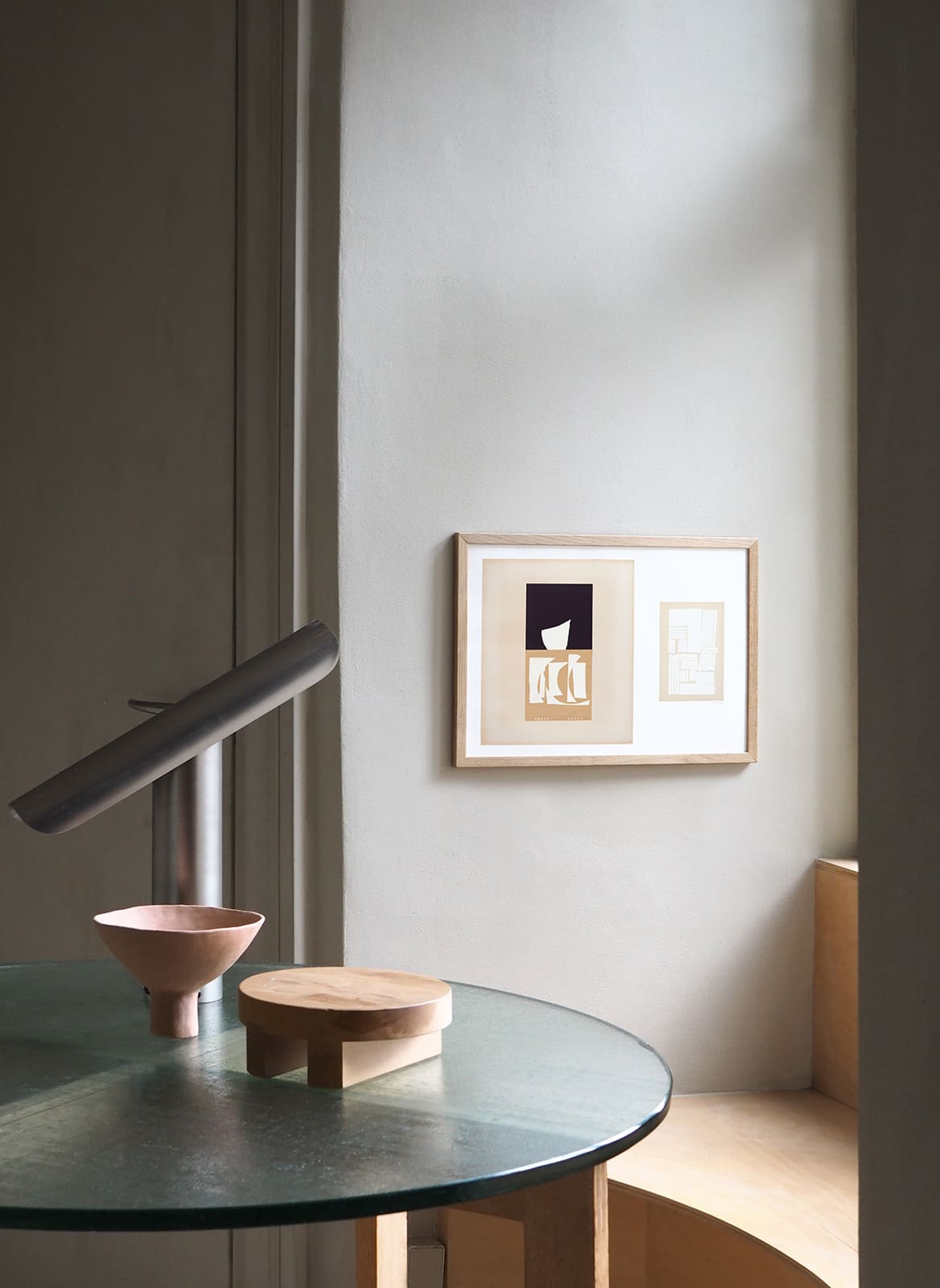  Framed minimalistic posters hanging above a table by Atelier Cph