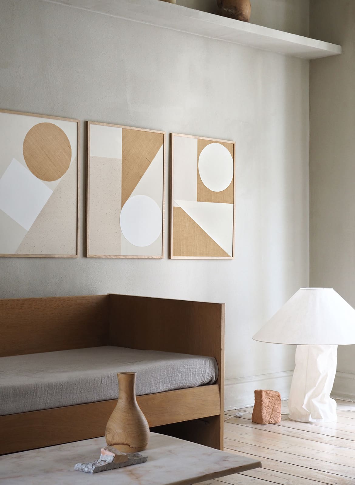 Three framed minimalistic posters hanging in a living room by Atelier Cph
