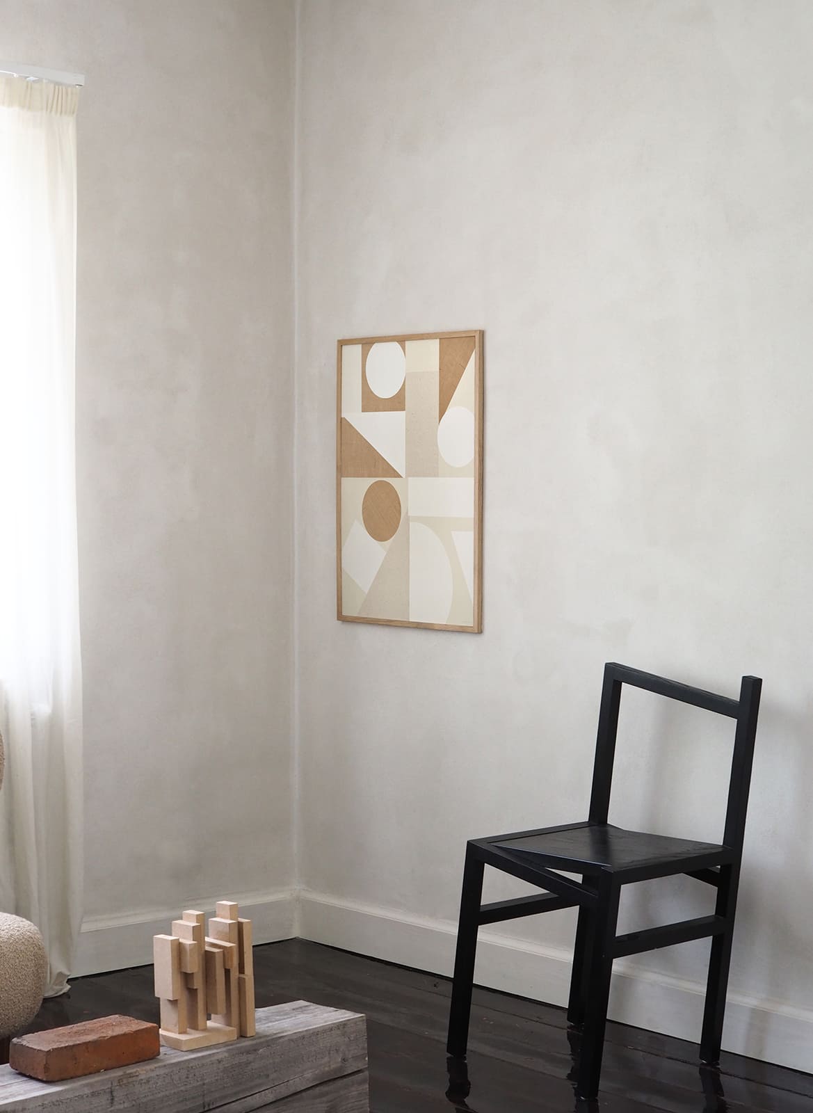 Framed minimalistic poster hanging in living room by Atelier Cph