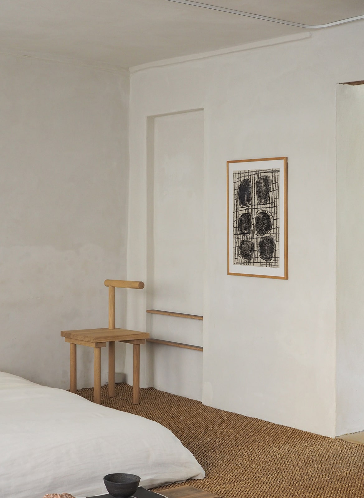 Framed poster with circles hanging in bedroom by Atelier Cph