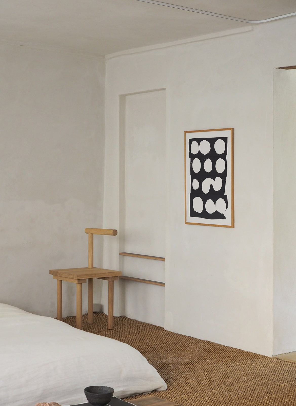 Framed poster with circles hanging in bedroom by Atelier Cph