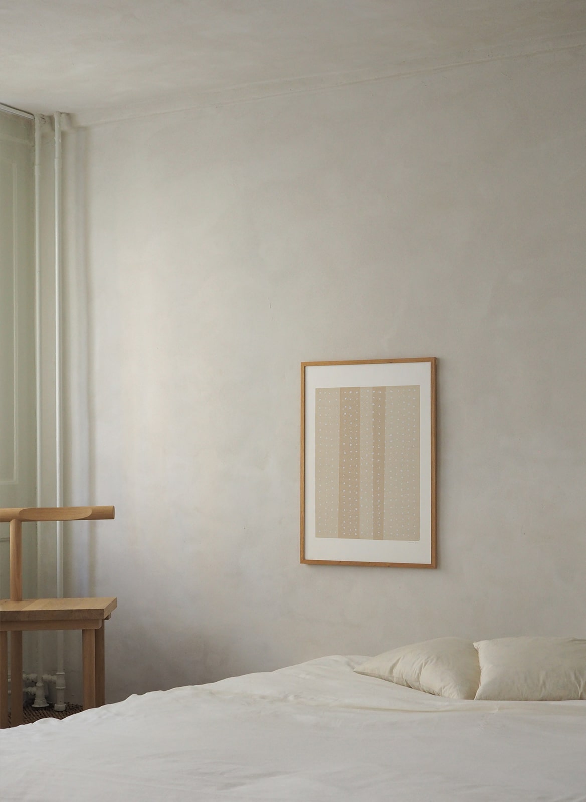  Framed poster with dots hanging in bedroom by Atelier Cph