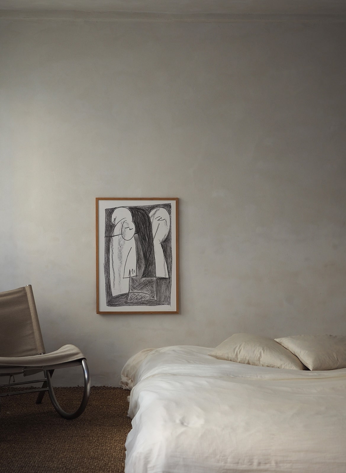 Framed poster with drawing hanging in bedroom by Atelier Cph