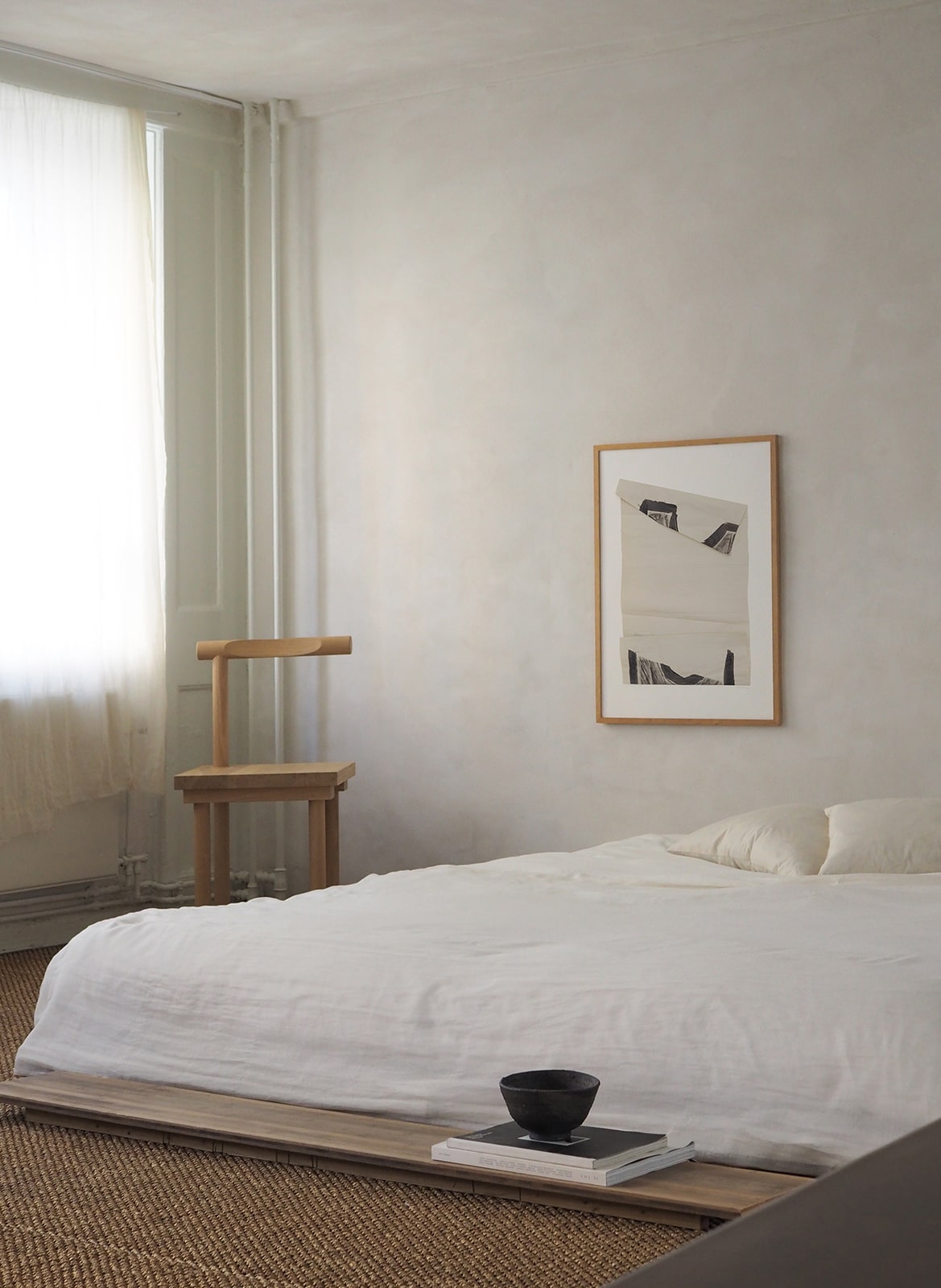 Framed minimalistic poster hanging in a bedroom by Atelier Cph