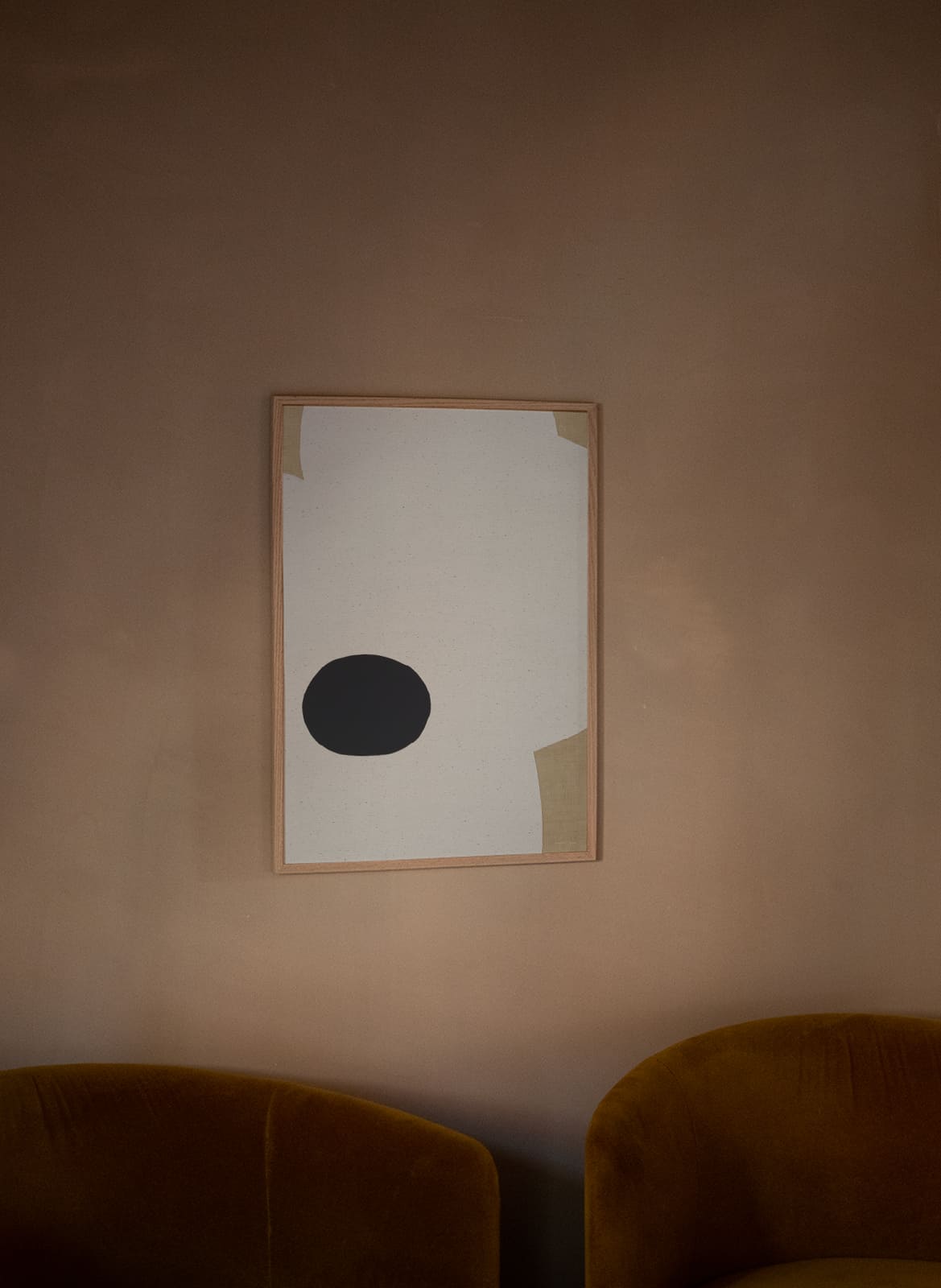  Framed minimalistic poster hanging above a couch by Atelier Cph