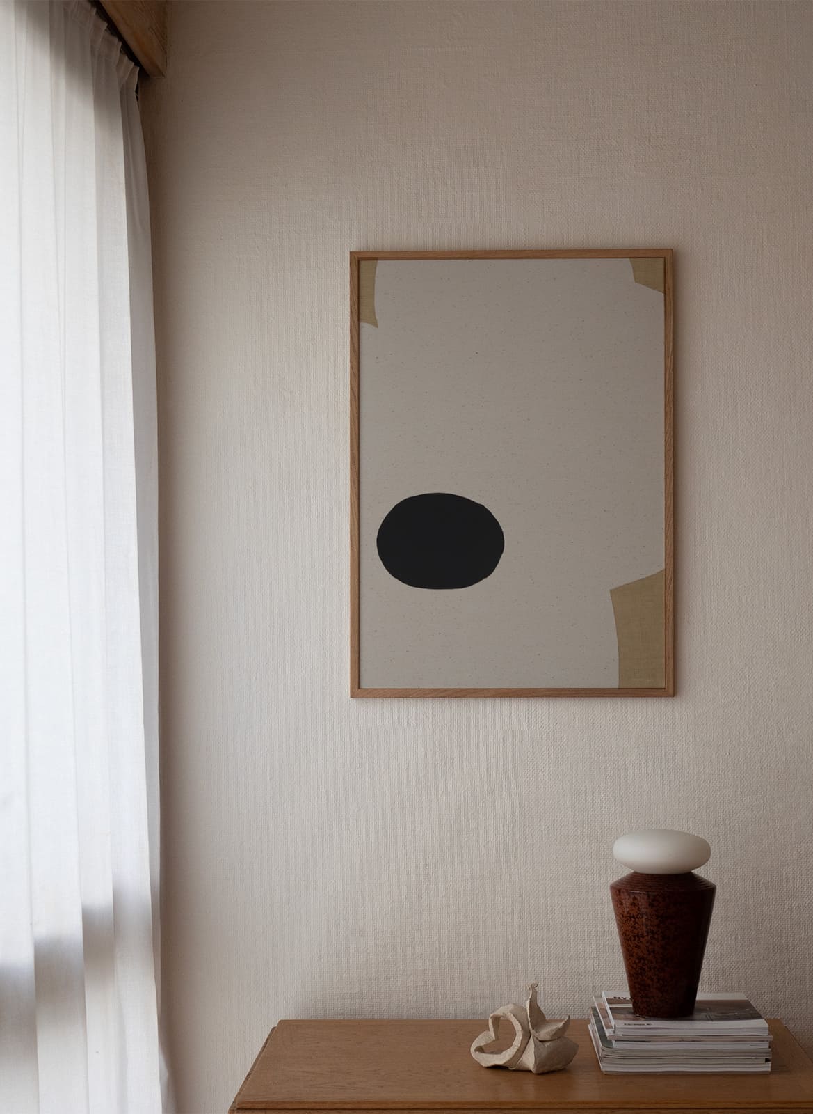 Framed minimalistic poster hanging in a living room by Atelier Cph
