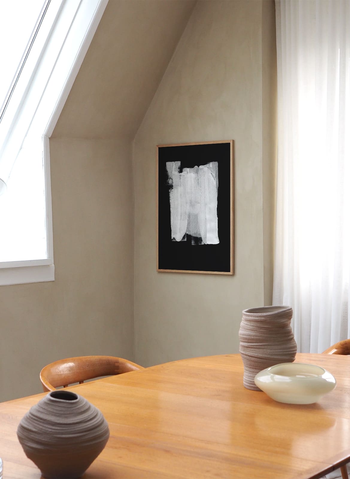 Framed black and white poster hanging in a living room by Atelier Cph