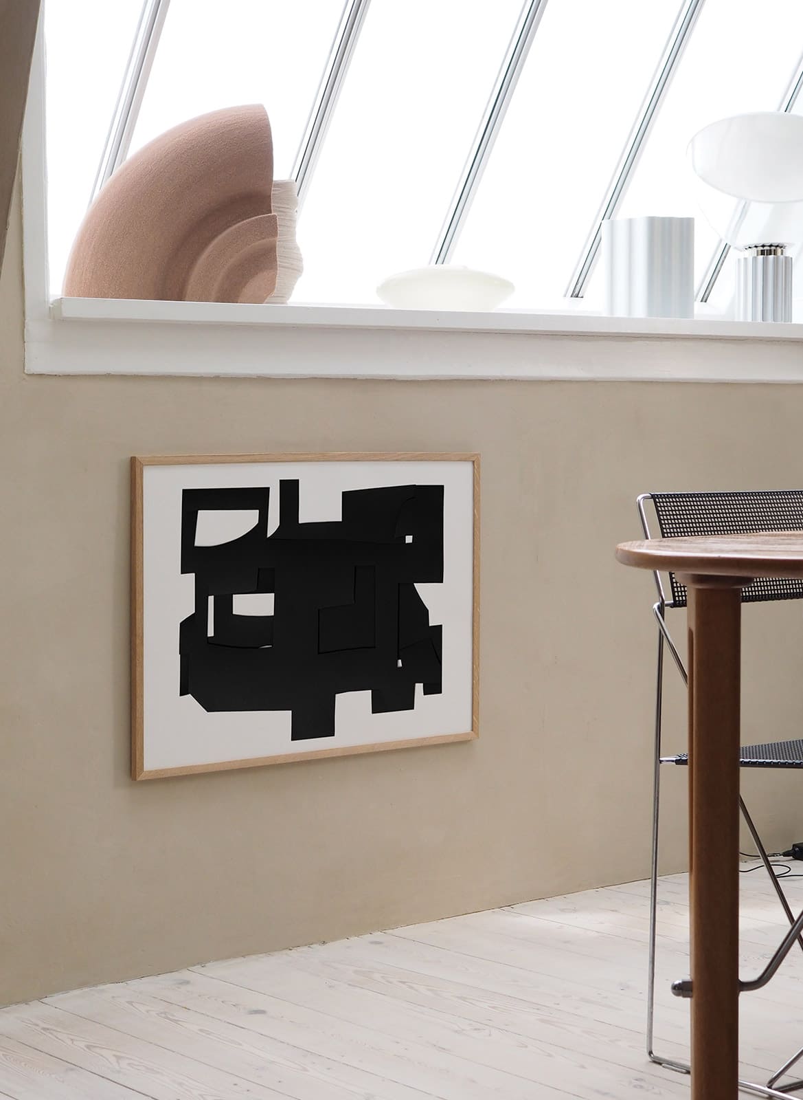Framed abstract poster hanging in a living room by atelier cph