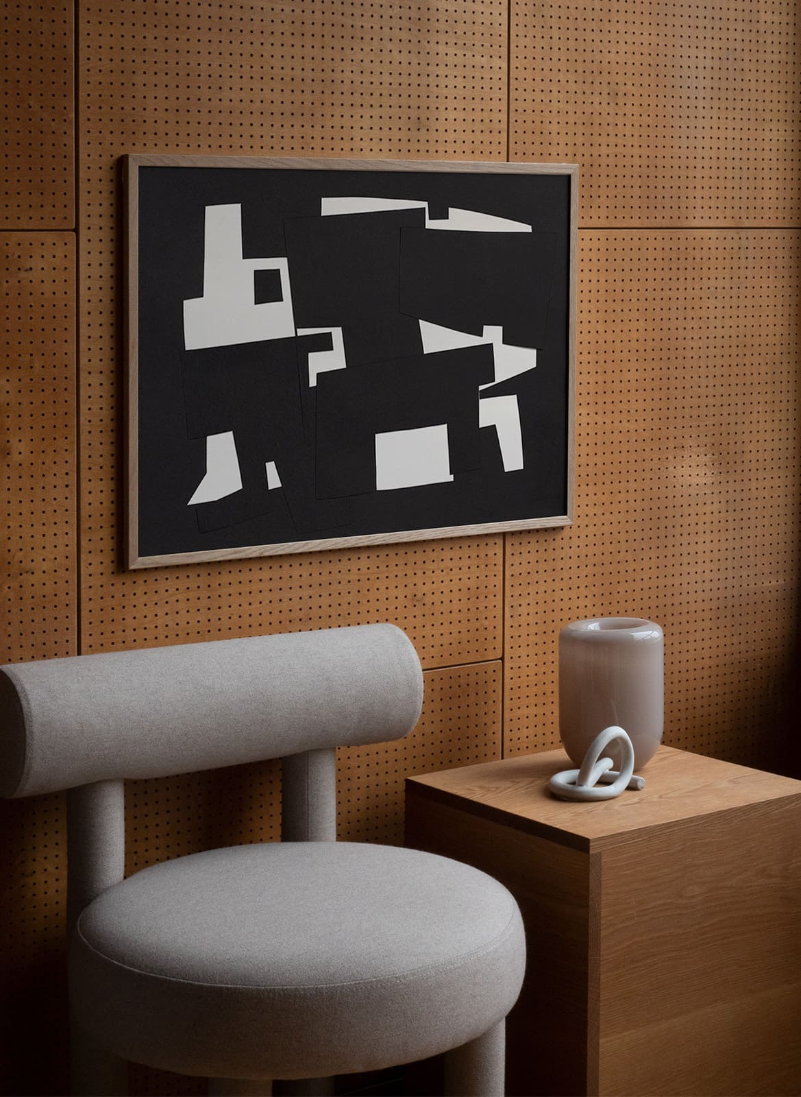 Framed abstract black poster hanging in a living room by atelier cph