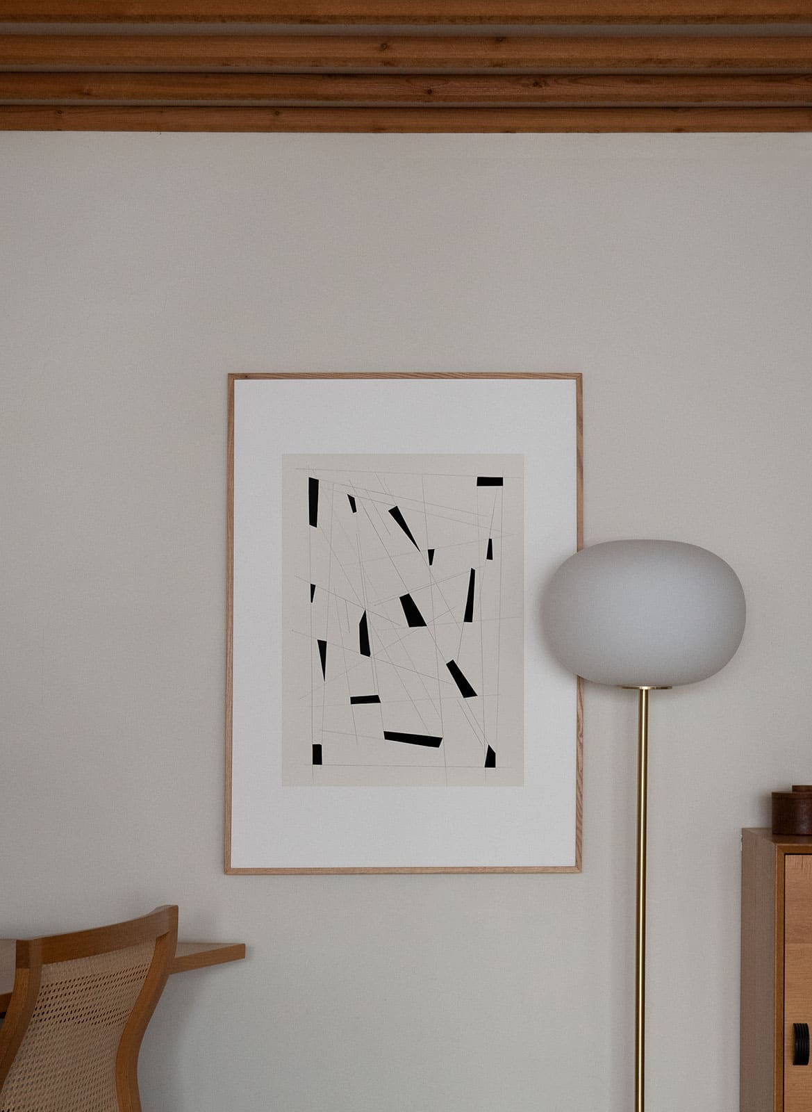 Framed graphic poster hanging in a living room by atelier cph